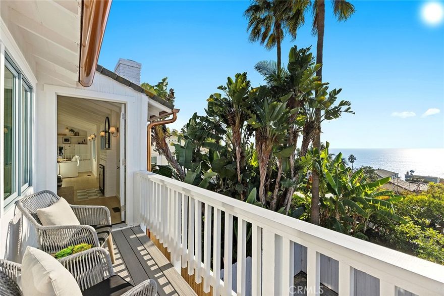 Perched above the shoreline in South Laguna Village, this newly remodeled (2025) coastal retreat spans approximately 2,055 square feet and showcases sweeping ocean and Catalina Island views with refined coastal living just moments from iconic Thousand Steps Beach. Natural light fills the entry level, which features a welcoming foyer, a spacious family room with custom built-ins, a combined bath and laundry area, and two secondary bedrooms—one opening directly to the backyard. The upper level impresses with wood-beamed vaulted ceilings and an open, connected layout that creates a warm atmosphere ideal for casual living and entertaining. The designer kitchen is appointed with white inset cabinetry, quartz countertops, a bookmatched quartz backsplash, new Thermador appliances, and a center island with bar seating. A pass-through serving window opens to the expansive ocean-view deck, ideal for al fresco dining and sunset gatherings. From the kitchen, the space extends to the dining area and a fireplace-warmed living room finished with classic Laguna Beach siding and a second balcony framing coastline views with stairs leading down to the side yard. The primary suite captures ocean vistas and includes a sitting area, an open flex space ideal for an office or retreat, and an ensuite bath with marble countertops. Additional highlights include white oak hardwood flooring, custom white oak cabinetry and finishes, designer lighting and hardware, a freshly painted exterior accented by all-new casement windows, shutters, and wood flower boxes, and a two-car attached garage with a custom mahogany wood door. Located on a quiet cul-de-sac, this residence embodies relaxed coastal sophistication in a sought-after Laguna Beach setting.