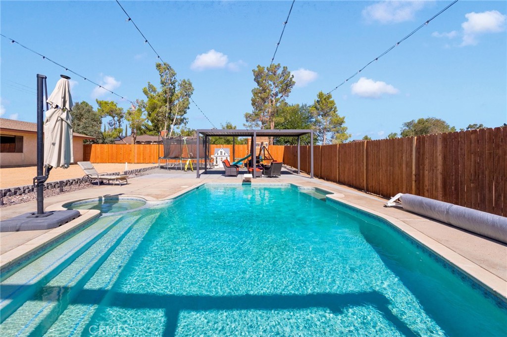 Room for Everyone in Desirable Desert Knolls!
Welcome to this spacious 5-bedroom, 2-bath pool home nestled on a generous .63-acre lot in the sought-after Desert Knolls neighborhood of Apple Valley! If you’ve been searching for a home with plenty of room to grow—this is the one!
Step through the formal entry into a bright and welcoming living room, a dedicated dining area, and a cozy family room with a fireplace—perfect for gathering. The open kitchen offers ample cabinet space, ideal for everyday living and entertaining.
Slide open the glass doors to your own private backyard retreat featuring a heated inground pool and spa, patio area, and outdoor shower—all perfect for hosting or relaxing under the High Desert skies. The backyard extends behind a wooden fence, offering even more space and privacy.
Located close to shopping, dining, movie theaters, and exciting new additions like Hobby Lobby, Sprouts, and Raising Cane’s, this home combines the best of space and convenience.
This home is also just minutes from Mojave Narrows Regional Park, a local gem offering year-round fishing, a disc golf course, equestrian trails, a playground, climbing rocks, a splash pad, and hiking trails. Nature lovers will appreciate that the park is home to over 1,500 species of watchable wildlife. For those who enjoy the great outdoors, there are even tent campsites along the shores of Horseshoe Lake and Pelican Lake.