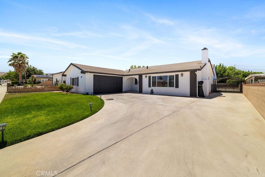 Price Reduced! Gorgeous, newly remodeled 5 room, 2 bath, single story, pool house. Farmhouse inspired. Amazing 2,430 sq foot living space that welcomes you with an open-concept floor plan. The entire house flows effortlessly.  Formal living room with fireplace. Modern kitchen featuring quartz counter tops, a chic tile backsplash, a center island and stainless-steel appliances. Microwave, dishwasher, refrigerator and stove are included with the sale! A second island is found in the wet bar that is connected to the second living room creating the perfect setting for entertaining! Sit down and enjoy a glass of wine or a cup of coffee watching the sunset or the sparkling pool.  Everything in this sleek home is 2 yrs old, floors, fans, chandeliers, doors, windows, blinds, garage door, pool equipment and heater, you name it!  Independent laundry room equipped with cabinets and a utility sink.  Electric washer & dryer also included.  A custom-built shower glass door was made for the master bedroom along with dual sink quartz counter tops. Property includes a back shed/storage room, RV access, covered parking and exterior lighting throughout.  Welcome to your new home!