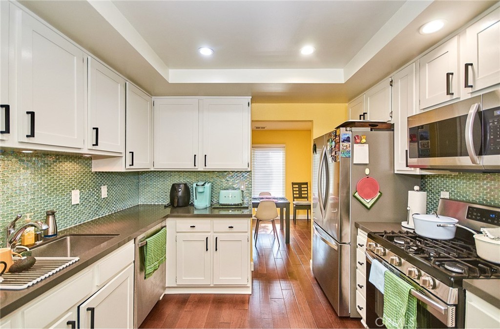 **Welcome to this beautifully updated townhouse in the desirable Heritage Village community! **
Tucked away at the back of the complex, this home offers exceptional privacy, safety, and tranquility with no through traffic. This spacious 3-bedroom, 2.5-bathroom residence features a private entrance with a charming custom water feature and unique front door, upgraded dual-pane windows, wood flooring throughout, and modern recessed lighting.
Step into the bright and airy living room with a cozy gas fireplace, seamlessly connecting to the dining area and oversized back patio—perfect for entertaining, kids, or pets. The patio also includes a gas line hookup for easy outdoor cooking.
The kitchen boasts quartz countertops, a custom mosaic backsplash, freshly painted cabinets, brushed nickel hardware, a gas stove, and a convenient breakfast bar. Adjacent to the kitchen is a versatile nook ideal for additional dining or a home office space.
Upstairs, the spacious primary suite offers a walk-in closet and a full en-suite bathroom. All bedrooms are generously sized with large closets for ample storage.
Additional features include a 2-car garage with storage space and washer/dryer hookups, central A/C and heating, and a well-maintained water heater.
Enjoy the many community amenities just steps away, including a pool, spa, clubhouse, and playground. The well-managed HOA maintains the grounds beautifully and covers water, trash, cable TV, internet, exterior maintenance (including roof, stucco, and fencing), and termite control. Recently replaced new fence.
Conveniently located near the 5 & 91 freeways, Knott's Berry Farm, Soak City, Splash Water Park, parks, shopping centers, restaurants, schools, golf courses, and more—this is a home and community you’ll love to live in!