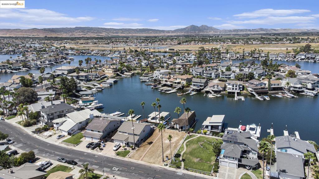 Delta Waterfront Lot with Fully Improved Boat Shed – Ready to Build! This rare waterfront parcel comes fully equipped with power, water, and sewer already in place—just bring your home plans! The custom boat shed features 200-amp electrical service, dual 50-amp boat outlets, multiple 20-amp outlets, a full bathroom with shower, kitchenette with appliances, laundry, and generous storage areas. Designed for stability with earthquake and wind tie-downs, the dock feels solid underfoot. Moorage for a 60’ boat inside the shed, plus side ties for additional vessels. Secure gated access with deadbolts throughout. Enjoy life on the Delta now while you plan your future dream home!
