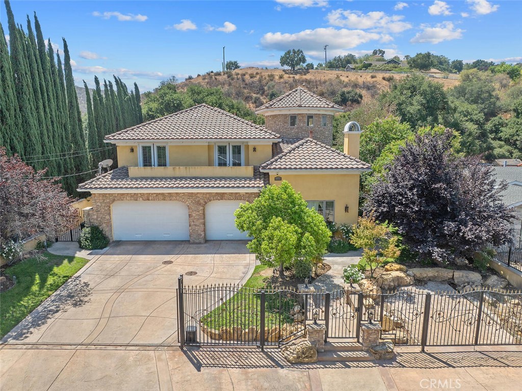 Stunning Custom Estate in Placerita Canyon! Welcome to this impressive 5-bedroom, 6-bathroom custom home nestled in the highly desirable Placerita Canyon. From the moment you step through the grand entryway with custom tile, you’ll be amazed by the home’s thoughtful design and luxurious finishes. The main level offers a spacious den/office with a fireplace. Entertain in your own elegant formal dining room. Downstairs you will also find a convenient half guest bath, and also a full bedroom and bath to provide ideal accommodations for guests. At the heart of the home, the chef’s kitchen boasts granite countertops, Miele appliances—including cooktop, ovens, and dishwasher—along with a Jenn-Air Subzero refrigerator/freezer. The kitchen seamlessly opens to the living area, creating a perfect space for gatherings and everyday living. Updated lighting fixtures, and hardware throughout elevate every detail. Upstairs, you will find a generous loft and large secondary bedrooms with a Jack-and-Jill bathroom. The spacious and grand primary suite features a spa-like bathroom and private balcony overlooking the serene surroundings. Step outside to your private backyard oasis, complete with a sparkling pool (built in 2014) and ample space for entertaining. The second garage offers additional storage and the potential for a pool house or ADU. This home also offers OWNED solar panels to enhance your peace of mind. This remarkable estate perfectly blends sophistication, comfort, and opportunity—all within one of Placerita Canyon’s most sought-after locations!