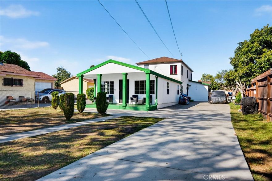 Welcome to 1803 E 109th Place, a spacious and versatile home offering over 2,600 sq. ft. of living space on a generous 7,600+ sq. ft. lot. Originally built as a duplex and later transformed into a single-family residence, this property carries a unique history and flexible layout perfect for large or multi-generational living. The home features 5 bedrooms, 2 bathrooms, and 2 additional bonus rooms, offering endless possibilities for a home office, gym, or guest suites. Step inside to find a large living room with a fireplace and windows that carry natural light throughout. The home flows seamlessly from front to back, carrying you into the “formal dining room" currently set up as a game room. Continuing back, you will find the great size breakfast nook and kitchen with fresh flooring, crisp white ceilings and recessed lighting. Furthermore, you will find a large primary bedroom, one full bathroom and two bonus rooms, one appointed with a brick fireplace. Upstairs, you will find four lovely bedrooms with great lighting and one bathroom. On the exterior of the property, the potential is endless.. With over 7,600 square feet of land, you have an oversized gated, multi-car driveway with RV/ Boat parking and the possible ADU potential for additional income. Conveniently located near major freeways, the Metro, central Los Angeles, shopping and schools, this home presents a rare opportunity to own a large property with limitless potential. Bring your vision and make it your own!
