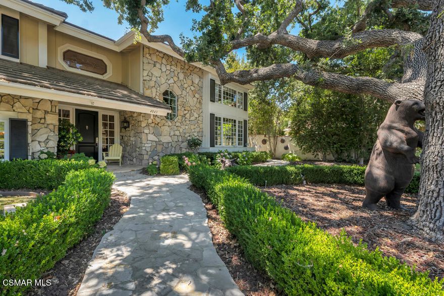 This is the ONE! EXCEPTIONAL QUALITY IN NORTH RANCH: If you value fine craftsmanship, timeless design, and attention to detail, this exquisite North Ranch estate is for you. No expense was spared in the construction and design of this traditional masterpiece executed with refined taste and top-tier materials throughout.A dramatic two-story foyer and custom-crafted staircase set the tone upon entry. Gorgeous walnut floors run throughout most of the home, complemented by designer carpeting and extensive use of classic white Carrara marble. The chef's kitchen is a true showpiece, featuring rich wainscoting, intricate custom millwork, top-of-the-line gourmet appliances, a walk-in pantry, and French doors that open to the backyard.The flexible floor plan offers two inviting family rooms one of which could serve as a spacious bonus room. Throughout the home you'll find stunning hand-hewn beams, floor-to-ceiling wainscoting, and bespoke cabinetry. An impressive oak-paneled office with detailed wall and ceiling treatments provides an ideal work-from-home setting.The luxurious primary suite offers a peaceful retreat, complete with a cozy fireplace, an elegant marble bathroom with a steam shower, and a fully customized walk-in closet. Upstairs are three additional bedrooms and two beautifully appointed bathrooms.Outside, the private, wooded yard is an entertainer's dream, with a pebble-finish pool, spa, and cascading waterfall. A covered loggia with fireplace, a built-in BBQ island, and bar seating create the perfect outdoor living and dining spaces.Additional features include a 4-car tandem garage, plus fully payed for 34 panel solar system that reduces huge cost to almost nothing. All on an incredible lush  tree lined lot with  such a sense of privacy.A rare offering in the heart of prestigious North Ranch uncompromising in quality, and rich in character.