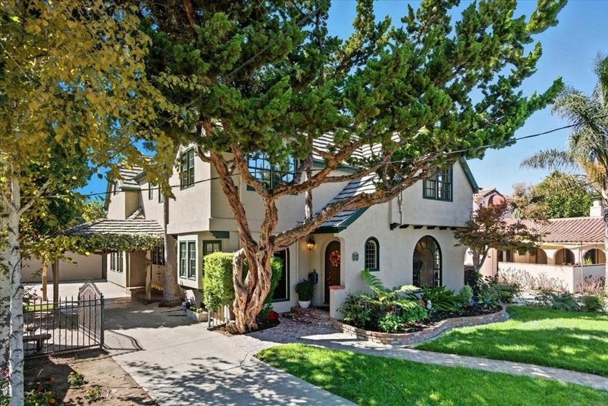This Palm Haven beauty-known for its historic palm-lined streets & summer porch parties is a custom-built French Tudor 1995 remodel. Brick Herringbone walkway leads to leaded-glass & marble foyer, LivRm w/original Oak floor & gas fireplace w/marble surround & formal dining seats large gatherings. Kit=Oak wood floors, Cherry wd custom cabinets w/matching panel-frig doors, built-in hutch w/pull-out shelves, Corian island counter, gas stove & built-in microwv/double oven/dishwash & pendant lighting. FamRm has French doors w/open views to nice grounds that border Los Gatos Creek & "Mad Woodchuck" designed cabinetry+high-end carpet. 270+/- SF game room has plenty of natural light. Main-level bedrm has built-in desk+shelves & bath on same level has been tastefully remodeled (Aug. 2025). Leaded glass window leads to upstairs primary bedrm w/high ceiling, Juliet balcony & 2-way FP w/Tudor-inspired sitting area & dormer windows. Primary bath has dual marble-top vanities, soaking tub+huge shower. All bedrms have ceiling fans, walk-in closets, natural light & share large hall bath. Double-hung windows w/wood casement/multiple stained glass windows/copper piping & upstairs A/C. 1.5 miles to Shark Tank, 3 blocks to Downtown Willow Glen & 10 min. to San Jose Airport-Prime Silicon Valley Living