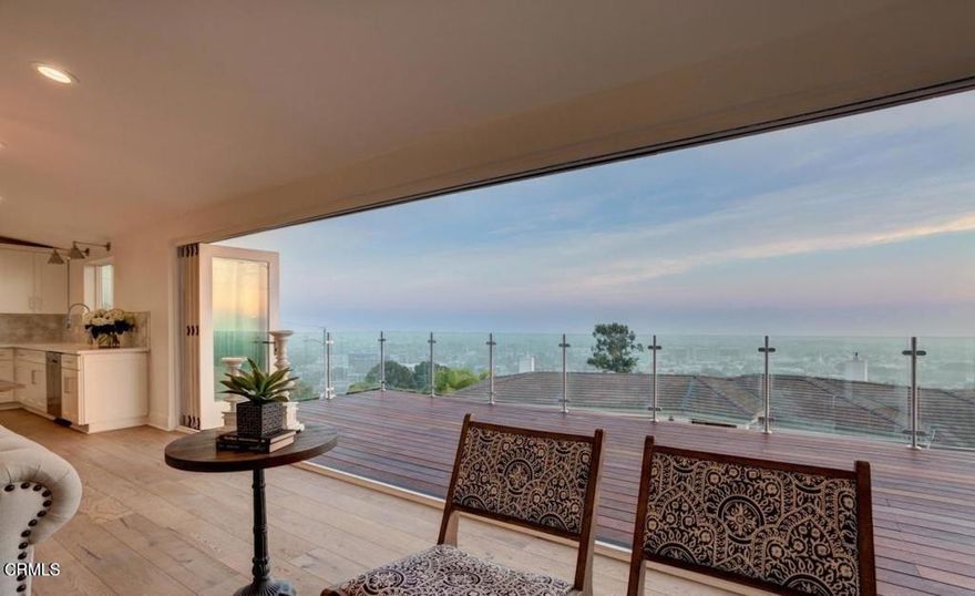 This breathtaking home is truly a gem. Featuring 4 bedrooms and 2 bathrooms, the property has been meticulously updated. The 660 sq. ft. panoramic ocean-view deck, accessible via an impressive 21-foot accordion door, is perfect for enjoying coastal breezes. The gourmet kitchen boasts a marble waterfall island, a Wi-Fi-enabled refrigerator, top-of-the-line stainless steel appliances, and a butler's pantry. The living room and spa-like primary suite both feature fireplaces, with the primary suite offering a soaking tub, standalone shower, and walk-in closet. French doors lead from the primary bedroom to a wraparound ocean-view deck. The 4th bedroom, which can double as an office, opens onto the backyard patio. A spacious laundry room with ample storage completes this must-see home.