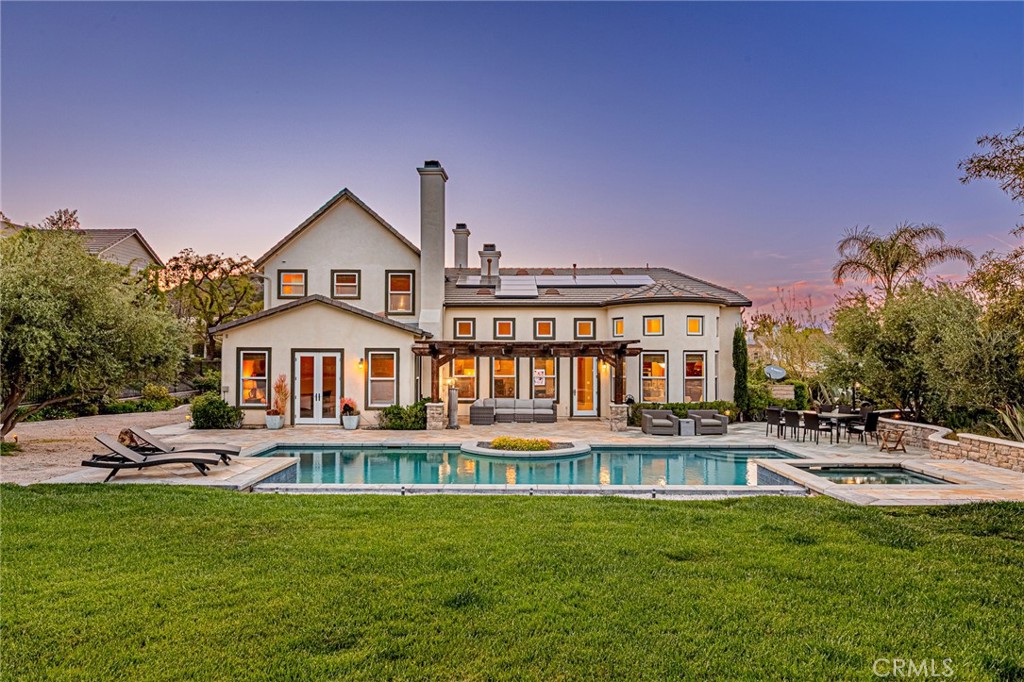 Sensational Sand Canyon Executive Home with Exceptional Pool and Spa Over Half an Acre.
Welcome to this spectacularly upgraded Executive home, nestled in the prestigious and scenic Sand Canyon Country Club neighborhood. Located on a quiet cul-de-sac and secured behind a private gate, this residence offers luxury, privacy, and impeccable design throughout.
As you arrive, you’re greeted by a separate Casita, perfect as a guest suite, workshop, or maid’s quarters. Step inside the main home and be captivated by the stunning layout, which offers a seamless and natural flow through the living spaces. Elegant travertine flooring with marble medallion, soaring high ceilings, and a cozy fireplace in the living room set the tone for refined comfort, while French doors open to a charming courtyard, perfect for peaceful moments or entertaining.
The spacious formal dining room flows into a Chef’s dream kitchen, complete with a Quartz stone island, full designer backsplash, built-in refrigerator, double dishwashers, double ovens, food warmer, and a bright breakfast nook. The highly ungraded adjacent family room features hardwood flooring, a fireplace, and a surround sound system, creating an ideal space for gatherings.
The expansive 1st floor level Master suite is a true retreat, boasting a fireplace, walk-in closet, and French doors that open to the serene backyard. The luxurious en-suite bathroom offers a jetted tub, extended separate shower, and elegant finishes.
Upstairs, you’ll find a spacious loft and two generous bedrooms, each with its own en-suite bathroom. Two additional well-sized bedrooms are located on the 1st floor level, offering flexibility and convenience. A large individual laundry room with a utility sink, Central Vacuum system, and an attached three-car garage with EV charger add to the home’s functionality.
Enjoy the best of Southern California outdoor living in the private backyard oasis, featuring a gorgeous pool, spa, and lush green lawn and trees—perfect for both relaxation and entertainment. The home is also equipped with 36 leased solar panels (only $195/month), low HOA dues, and no Mello-Roos tax.
This home is truly a masterpiece—a rare blend of elegance, comfort, and thoughtful design. Seeing is believing—schedule your private tour today!