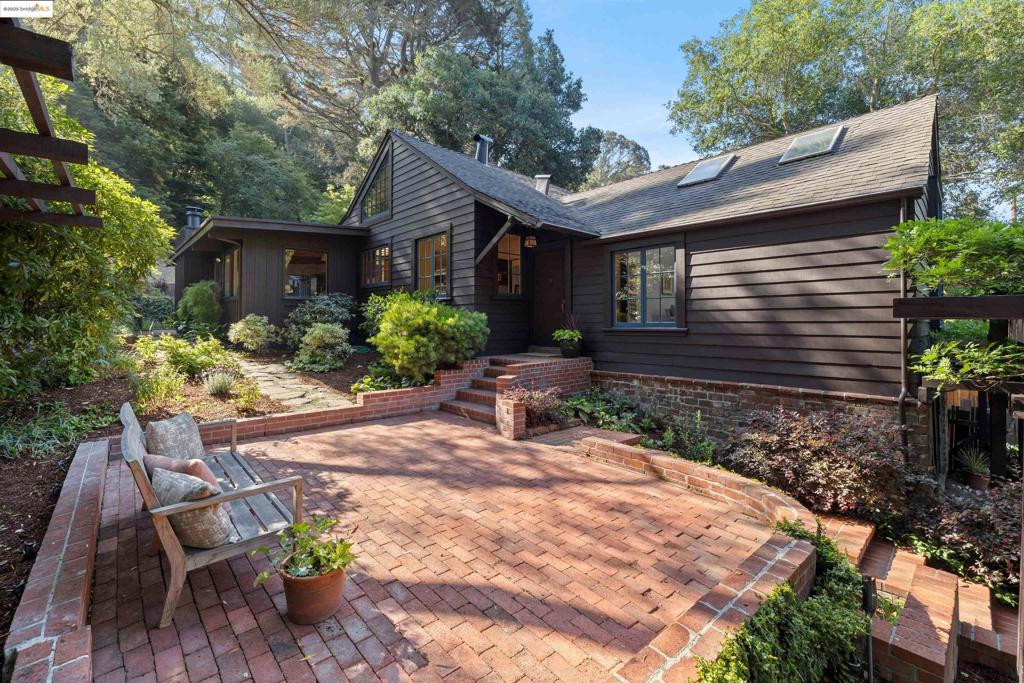 Tucked within the heart of Montclair is a house so charming, it feels lifted from a storybook. Cross the wooden bridge and the world begins to soften, and the hum of everyday life gives way to birdsong and the rustling of leaves. In 1935 John Frederick (“J.F.”) Altermatt built this and the house next door. Here the quiet beauty of nature meets timeless character yet an addition in 1983 brought the home into the modern era with a primary suite and kitchen/family room combo! Step inside to a stunning entry, light-filled living room with soaring ceilings, hardwood floors, a grand stone hearth, and a large multi-paned window that gazes out into the trees, framing the forest as though it were a living portrait. The kitchen, off the dining room, WOWS as it opens onto a bright airy family room with a Dutch door leading level out to the first of many outdoor patios. This home on a .49A lot was made to celebrate the landscape around it and to be a part of it whether dining, reading or swinging in a hammock. The two-car garage and generous driveway offer space for guests, though they may never want to leave. A perfect blend of history, charm & nature, that feels far away from the real world and yet is only minutes to coffee, beer with friends, great farmer’s market and Thornhill Elementary