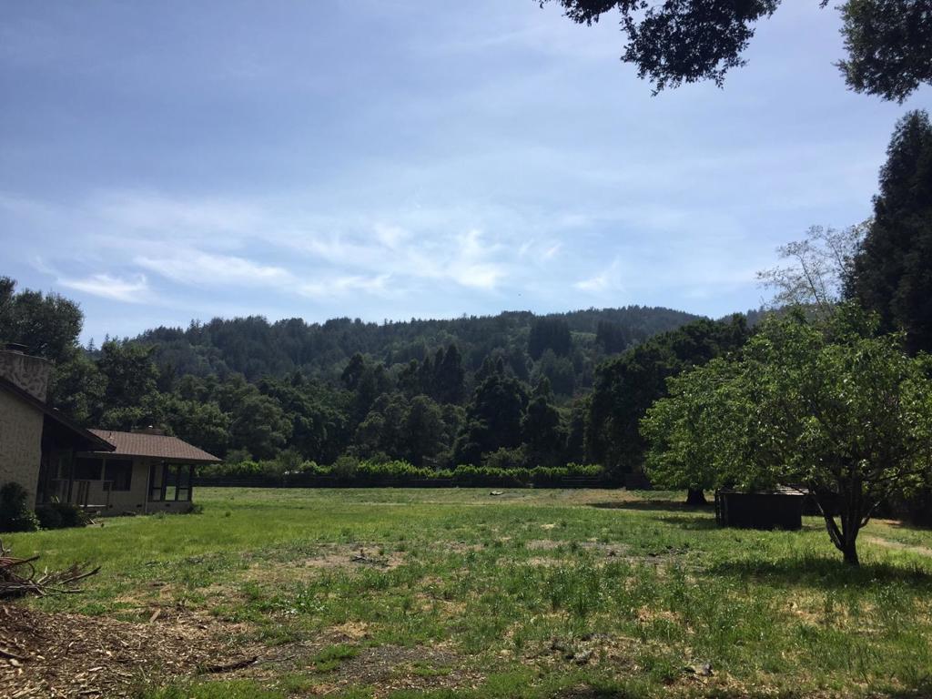 One of the few remaining truly exceptional flat view lots in central Woodside. 4.2 very private level acres with panoramic Western Hill views, secluded, with gated entrance at the end of a private lane. Fully usable and picturesque equestrian property, sunny and open yet framed with beautiful heritage oaks and redwoods.