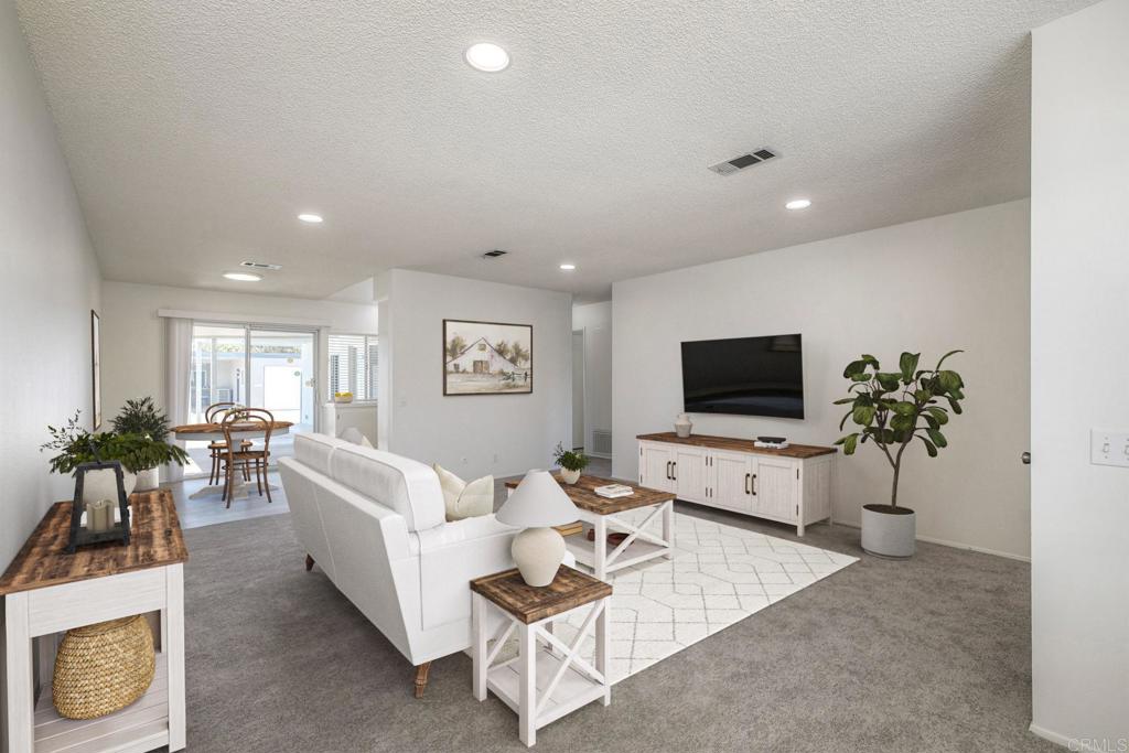 Discover the relaxed lifestyle at Oceana! Welcome home to this light-filled, single-level 2 bedroom, 1 1/2 bath home that is move-in ready with brand-new luxury vinyl plank flooring, plush carpet, fresh paint, and refreshed kitchen countertops. Enjoy the convenience of your own washer and dryer in the single car garage, plus a private outdoor patio—perfect for morning coffee or evening unwinding. Both bedrooms feature spacious closets, and the primary bathroom includes a walk-in shower for easy access. The second bedroom with its own half bath makes a great guest retreat, home office, or craft room—whatever fits your lifestyle best. Oceana is a vibrant 55+ community with endless amenities. Stay active with art classes, clubs, fitness, and games. The Community Center features a clubhouse with auditorium and stage, card and computer rooms, a library, and pickleball court. Relax on the sunny patio by two solar-heated pools and a year-round jacuzzi, or explore the wood shop, ceramics studio, billiards, and lapidary shop. Golf enthusiasts will love the easy access to the community course. All this just minutes from shopping, dining, entertainment, and the beach—your perfect Oceanside retreat awaits!