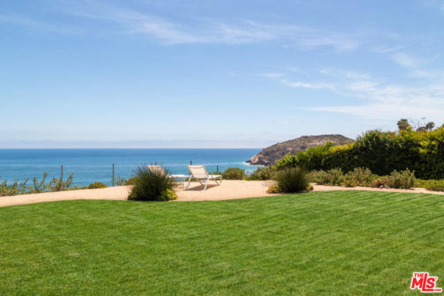 An iconic mid-century ranch graces the Point Dume bluff with breathtaking panoramic ocean views. This tastefully appointed 4bdrm/3bth home is thoughtfully updated inside and out. Ocean views abound from almost every room, a spacious entry flows into a high-ceiling living room with a wood burning/gas fireplace. Walls of glass open to the outdoor entertaining area, exquisitely landscaped grounds and expansive ocean views; fully remodeled chef's kitchen, breakfast bar and separate dining area; master suite with ocean views, walk in closet and spa-like bath with radiant heated floors and private patio with outdoor shower; plus 3 ocean view bedrooms with sliding glass doors to the yard; Sonos™ sound system; keyless entry; and 2-car garage. Additional amenities make this turnkey Malibu residence the perfect place to call home or a weekend retreat.