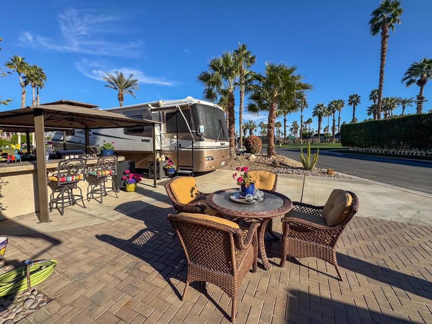 If you love pickleball, golf, and resort-style living, this centrally located luxury RV lot is the perfect choice! Situated on the 11th hole with park-like golf course views, this lot offers a front-row seat to activities and events while maintaining privacy with rarely a golfer passing by. Just steps from ORI's six pickleball courts, the clubhouse, cafe, and resort amenities, this lot keeps you close to the action while ensuring a peaceful retreat. A wider street makes pulling in easy, and plenty of parking space accommodates your RV, car, and golf cart effortlessly.Designed for both entertaining and relaxation, the well-maintained outdoor kitchen features a built-in grill, bar, and ample storage, complemented by two Sunbrella sun covers with ceiling fans for all-day comfort. The spacious back area with extended pavers provides the perfect setting to unwind. With updated electrical, beautiful views from both ends, and a peaceful atmosphere, this lot is a rare find for those who want the best of privacy, convenience, and luxury RV living.Outdoor Resort Indio is a class A RV resort.