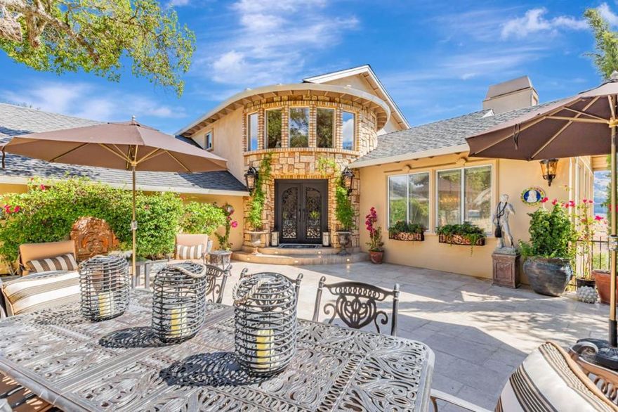 Welcome to this exclusive gated estate in Holiday Lake Estates, Morgan Hill near Rosendin Park hiking trails.  Set on nearly 36,000 sq. ft., this 3,689 sq. ft. home offers breathtaking panoramic views and unmatched craftsmanship.  The interior boasts soaring ceilings, imported Italian travertine floors, custom crown molding, and hand-painted murals.  A Swarovski crystal chandelier highlights the grand staircase.  The gourmet kitchen features a Carrara marble island, stainless steel appliances, and a custom backsplash.  The primary retreat impresses with 15-foot ceilings, a fireplace, sitting area, walk-in closet, and a spa-inspired bath with onyx counters, Jacuzzi tub, and a rain shower.  Additional highlights include multiple fireplaces, a guest suite with full bath, and a remarkable 1,000 sq. ft. custom wine cellar (not incl. in home square footage) with 11-foot ceilings and slate floors - perfect for entertaining.  Enjoy outdoor living in a private paved courtyard or on the hillside-view patio.  A three-car garage with custom doors, wrought iron security gate, indoor laundry, and room for a pool complete this estate.  Blending elegance, artistry, and functionality, this home offers a truly tranquil Morgan Hill retreat.