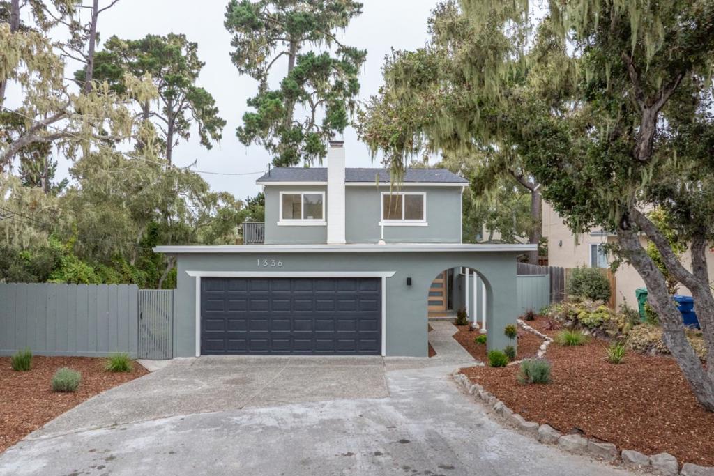 Nestled at the end of a peaceful cul-de-sac in Pacific Grove, 1336 Lawton Avenue is a thoughtfully reimagined 3-bedroom, 2.5-bath residence offering 1,866 sq. ft. of beautifully updated living space on a generous 7,600 sq. ft. corner lot. Blending coastal charm with modern updates, the home creates a warm and welcoming retreat. The main level features a cozy family room centered around a fireplace, perfect for gathering on cool coastal evenings. Beyond, a bright living and dining area with wood-beamed ceilings and expansive windows frames views of the lush backyard, filling the space with natural light. The updated kitchen boasts sleek finishes, a walk-in pantry, and ample counter space for both everyday cooking and entertaining. A stylish half bath completes the downstairs. Upstairs, all three bedrooms enjoy serene views of the surrounding greenery, while the remodeled bathrooms showcase beautiful, thoughtful design. Just steps from scenic walking trails and minutes from downtown Pacific Grove, Fisherman's Wharf, Pebble Beach, and Carmel-by-the-Sea, this home offers the perfect blend of comfort, beauty, and convenience.