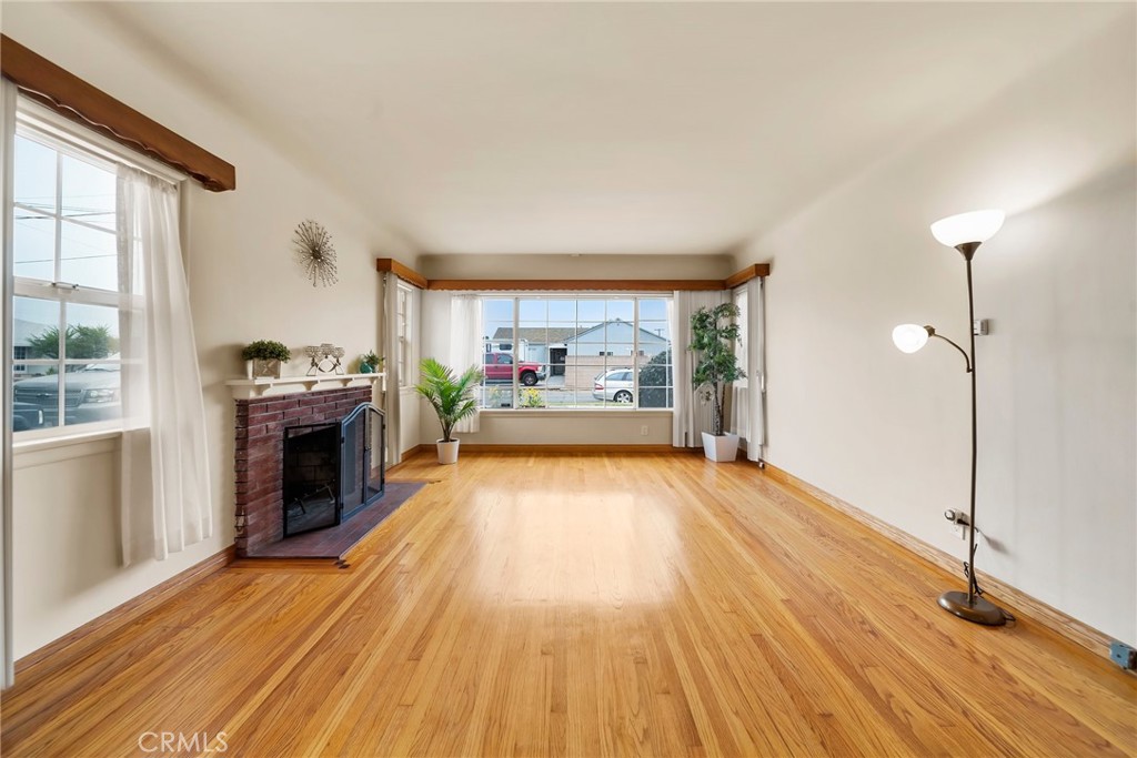 This lovely 3-bedroom, 2-bathroom home is nestled on a quiet street in the highly sought-after Torrance Unified School District. Freshly painted inside, the bedrooms (new closet doors in 2 of the bedrooms), the family room and hallway, the home features a spacious layout with excellent flexibility. A standout feature is the large family room with its own bathroom and private entrance — ideal for use as in-law quarters, a studio, guest suite, or home office. The bright and airy living room offers a cozy fireplace and a large window that brings in an abundance of natural light. You'll also enjoy the updated bathroom and a charming eat-in kitchen, perfect for daily living and casual dining. Step outside to a backyard filled with fruit trees, offering a peaceful space for relaxation and entertaining. A long driveway leads to a detached garage, providing ample parking and storage. Conveniently located near shops, restaurants, supermarkets, and freeway access — and just 15 minutes from the beach — this home combines comfort, convenience, and coastal lifestyle.