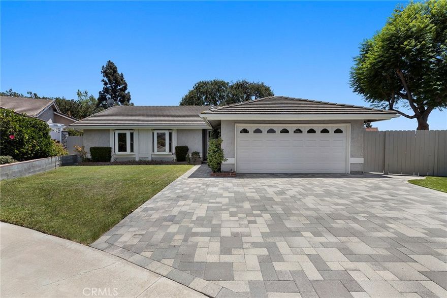 Looking for an impeccable well maintained lease property?  This is the one! Tucked away in a quiet cul-de-sac, this SINGLE LEVEL home offers a great combination of comfort, style, and convenience.  Impeccable curb appeal begins with the sturdy paver driveway with expanded parking and small RV potential.  Now,  step inside to the separate formal living room boasting wood laminate flooring and a charming brick fireplace for those cooler nights.  The remodeled kitchen featuring sleek granite countertops, rich cabinetry, and all major appliances — including a refrigerator. The open layout flows into a cozy dining counter and seating area, perfect for casual meals or gathering with friends and family.  Across the back of the home is the spacious family room surrounded by walls of windows and a light-filled skylight, entrenching the area with natural light and peaceful views of the rear grounds.  You’ll find three generously sized bedrooms, two with bay windows that frame pretty front yard views. The upgraded full hall bath is stylish and functional, while the private primary suite features a double door entry, dual-sink vanity with granite counters, oil-rubbed bronze fixtures, and a walk-in shower with frameless glass enclosure.  Enjoy outdoor living at its best with two distinct patio areas: a covered paver patio perfect for relaxing in the shade or entertaining, PLUS a separate sunny open patio — great for soaking up the sun or enjoying a quiet evening under the stars. The low-maintenance yard is enhanced by artificial turf and vibrant planters for year-round curb appeal.  Located just minutes from the Yorba Linda Town Center, parks, favorite shopping, and dining options galore — this home checks all the boxes!