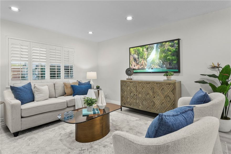 Welcome to one of South Huntington Beach’s best-kept secrets! This rarely available 4-bedroom “Bradford” floor plan in the VILLAGE TOWNHOMES offers space, style, and unbeatable value just minutes from the coast. With NEW LUXURY VINYL WATERPROOF FLOORING, fresh two-tone paint, and DUAL PANE WINDOWS, this home is move-in ready and made for modern living. Your journey begins at the peaceful greenbelt that leads right to your FRONT DOOR. Step into the tiled entryway and into a bright living space where LUXURY VINYL SHUTTERS frame every window and CEILING FANS keep the breeze moving. Around the corner, a convenient DOWNSTAIRS POWDER ROOM adds function to the layout. The dining area features recessed lighting and an open feel that flows directly into the UPDATED KITCHEN, complete with GRANITE COUNTERTOPS, bright white cabinets with MODERN BRUSHED NICKEL PULLS, STAINLESS STEEL APPLIANCES, and an EXTENDED COUNTER that doubles as a breakfast bar. Slide open the door to your PRIVATE PATIO, perfect for entertaining or relaxing. Just beyond, you’ll find COVERED PARKING WITH STORAGE plus an additional permitted space, all directly accessible from your patio gate for easy unloading. Upstairs, all FOUR BEDROOMS are generously sized, each with its own ceiling fan and abundant natural light. The FULL BATHROOM is finished with clean tilework and modern fixtures. Even the stairs have been upgraded with luxury vinyl plank for a cohesive, polished look throughout. Extras include a FULL-SIZE SIDE-BY-SIDE WASHER AND DRYER setup just off the kitchen, a LARGE PANTRY, and recessed lighting in key areas. The community features a sparkling POOL, SPA, TENNIS COURTS, BASKETBALL COURT, and lush GREENBELTS throughout. All of this, tucked quietly in the back of the community for privacy, and located within top-rated school boundaries in South Huntington Beach. This is more than a home, come see for yourself!