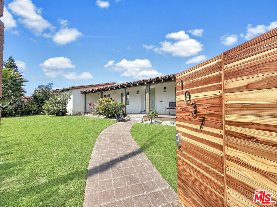 Welcome to this one of a kind meticulously reimagined Spanish style home, c. 1939, located in the historic Vermont Knolls neighborhood, known for its close-knit community. Situated on a 6,551 sf corner lot, one of the very few oversized lots in the neighborhood. Desirable floorplan featuring 3bd3ba that includes an outdoor patio in addition to an expansive back yard w/ lush landscaping. This residence offers loads of original charm complimented with modern elegance. The exterior has been finished with smooth stucco, a covered front porch, and Podocarpus trees with wood gate for complete privacy. Upon entry, you will be greeted with a foyer, elegant chandelier, and travertine stone floor. The architectural focus of the home are the beautiful vaulted ceilings, abundance of windows, and French doors pouring in natural light throughout the home. Super spacious primary bedroom with luxurious ensuite bathroom and French door that leads to the outdoor patio. Kitchen offers high end amenities, Quartz countertops with full wall backsplash and waterfall edges, Samsung Bespoke White appliances, custom two-toned cabinetry, Travertine stone floors, and opens to the formal dining room. Gleaming original wide plank hardwood floors, decorative brick fireplace, multi-zone split system, dual pane windows, new electrical, laundry area w/ washer/dryer, tankless water heater and surveillance cameras. All bathrooms have been tastefully remodeled with floating vanities, and glass enclosed shower doors. This home's most valuable feature is the expansive backyard surrounded with lush Ficus Trees for complete privacy. There is room for a pool or another house can be built on it. In addition to the backyard, there is an uncovered patio with travertine stone floor perfect for entertaining and gatherings. The outdoor space is endless! There is a detached 2-car garage with an automatic garage door. Come see it while its available!
