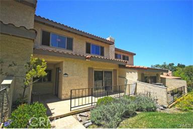 Charming ocean view unit with excellent floor plan in gated Mira Verde community. Remodeled 3 bedroom 3 bath with den/ office and newer wood floors throughout. Kitchen features custom built cabinets, newer appliances, and sweet built in breakfast nook. Master suite has newer bathroom. Generous living room has cozy fireplace. Large storage room in garage for further convenience. A must see in this security guard protected community with 2 large ground pools, basketball courts, tennis courts, and a clubhouse.