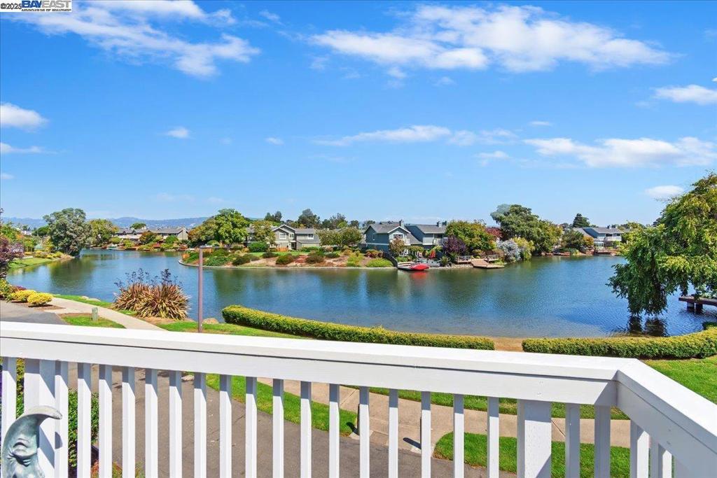 Discover a one-of-a-kind, move-in ready gem. This exceptional home, featuring three bedrooms and two fully remodeled bathrooms, is uniquely positioned to offer spacious privacy from neighboring units. The amenities of this gated community include a pool and spa, enhanced by walking paths winding among the lagoons leading to the bay shore and park. Access to the home entrance is bordered by beautiful and lush greenery, and once inside, the airy and bright interior is framed by new windows that invite treetop views. The primary suite is a tranquil retreat with sweeping and serene lagoon views. The double patio doors open onto a generous balcony, perfect for relaxation and breakfasts al fresco. The second bedroom offers a cozy escape with its own fireplace, tall ceiling and corner windows. The third bedroom, customized with wrap-around closet cabinetry, serves as a flexible office space or guest room. Both bathrooms were remodeled with custom cabinetry and storage The kitchen and dining area feature custom cabinetry and premium appliances. This is a rare opportunity to own a remarkable home with natural beauty and thoughtful functionality. Don't miss this one!