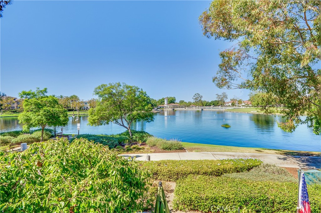 Beautiful lakefront condo offering the best location and views in all of Brisa del Lago! This light-filled and spacious two-bedroom home is move-in ready, featuring soaring ceilings and stunning new laminate wood flooring throughout. The inviting living room showcases a newly tiled fireplace and modern chandelier, while the remodeled kitchen boasts sleek quartz countertops with new backsplash, newer cabinetry, and new LG stainless steel appliances, including a new refrigerator. The open layout flows seamlessly into the dining and living areas, making it ideal for entertaining.Enjoy panoramic lake views and front-row seats to the RSM fireworks from the private balcony. The spacious primary suite offers direct balcony access, dual wardrobe closets, new LED lighting, and a luxurious remodeled en-suite bathroom with new dual sinks, new quartz counters, custom cabinetry, and a new walk-in shower with frameless glass doors and designer tile. The upstairs bedroom is bright and versatile with its own balcony, perfect as a guest room or home office. Additional upgrades include a newer A/C and furnace, newer water heater, newer garage door and opener, interior doors, baseboards, blinds, new switches. Convenient in-unit laundry with washer and dryer included. Parking is easy with a detached one-car garage plus a covered carport just steps from your door. As a resident of Rancho Santa Margarita, you’ll enjoy access to the Lago RSM Beach Club, scenic trails, parks, tennis and pickleball courts, multiple pools, and a variety of dining and shopping options—all within minutes of top-rated schools and the 241 Toll Road. This is truly a rare opportunity—don’t miss it!