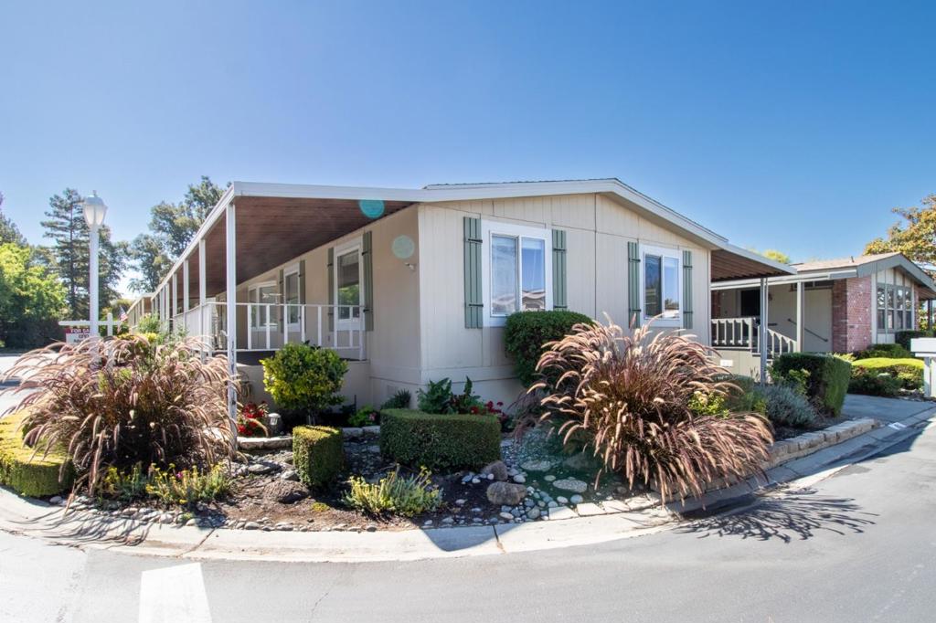 Located in one of San Jose's most sought-after senior communities, this beautifully maintained 2-bedroom, 2-bath home offers 1,488 sq. ft. of comfortable living space plus a versatile bonus room perfect for a home office, hobby space, or guest area. Built in 1976, this residence features unique hardwood flooring, freshly painted interiors, and an inviting split floor plan. The kitchen boasts ample cabinet space, a center island, and easy flow into the dining and living areas. Large windows fill the home with natural light, highlighting the warmth of the wood accents throughout. Enjoy year-round comfort with central heat and A/C, and take advantage of two convenient storage sheds. The long covered porch offers the perfect place to relax while enjoying the beautifully landscaped surroundings. Situated on a peaceful corner lot toward the back of the park, you'll appreciate privacy while being just steps from guest parking and the clubhouse. Experience the comfort, convenience, and community of Millpond - schedule a tour today!