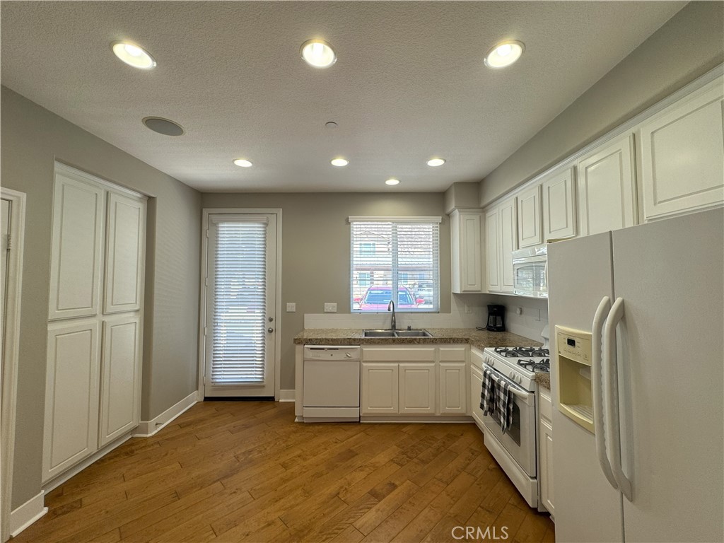 Welcome to this beautifully remodeled and furnished ground-floor condo in the gated 55+ community of Peppertree in Hemet. This 1-Bedroom, 1-Bathroom home was remodeled in 2022 and offers a bright and open floor plan with stylish wood flooring, a sleek kitchen featuring granite countertops, white cabinetry, a subway tile backsplash, and matching appliances. The spacious bedroom includes a generous closet and plush gray carpeting, while the upgraded bathroom boasts a large walk-in shower and modern fixtures. A built-in desk provides the perfect nook for a home office too! Enjoy convenience with an in-unit laundry and private patio to enjoy your morning coffee. Built in 2008, this turnkey home is low maintenance and ideally situated in a quiet, tucked-away location within the community, offering extra parking and peaceful surroundings. Residents enjoy access to resort-style amenities including a clubhouse, pool, spa, billiards room, and more. Conveniently located near shopping, dining, and entertainment, with easy access to Temecula Wine Country. This home is the perfect blend of comfort and style!