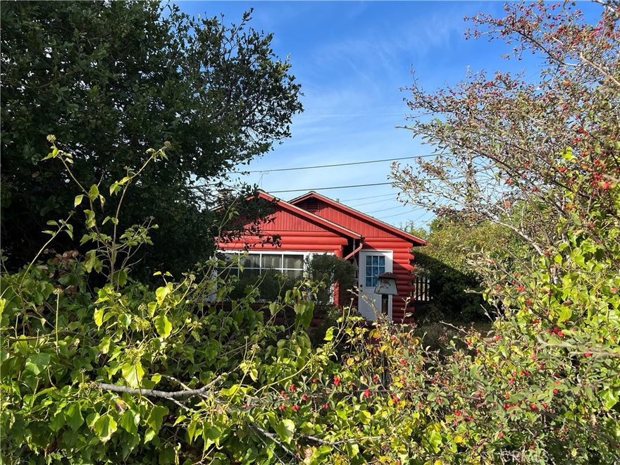 Geranium Cottage. A step back in time with this original 1930's log cabin on Yorkshire Dr. Located near the Cambria Pines Lodge and easy access to Hwy One and Downtown Cambria. Newer exterior and interior paint. There's a living room rock fireplace, kitchen, 1 bedroom, 1 full bath & a detached 1 car garage (with a bathroom) on a street to street landscaped double lot. A large hedge along Burton Drive assures your private retreat. Sold As Is, offered for $595,000.
