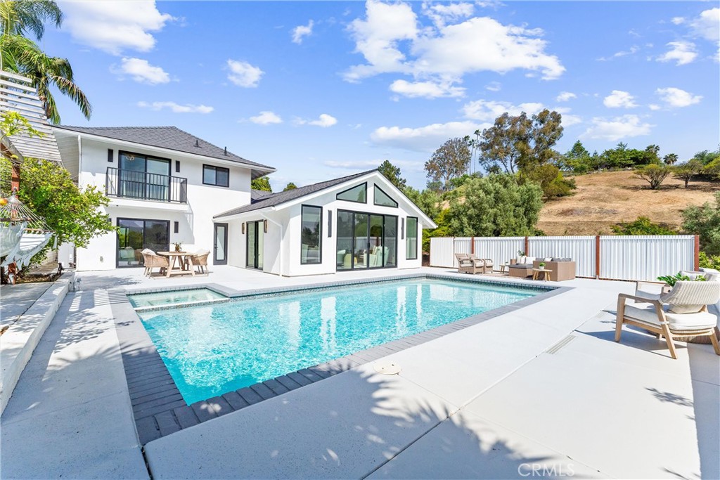 PRICE IMPROVEMENT! Fully remodeled, turnkey home at exceptional value. Move-in ready coastal retreat with hill, city lights and sunset views. This 5 bedroom, 3.5 bathroom pool home, located in the highly sought after Pacesetter community of Laguna Niguel, underwent an extensive remodel and complete renovation in 2022. This home was redesigned inside and out. Ideal location across from La Hermosa Park and scenic, hillside trail. Step through the stunning, pivot front door into this contemporary retreat with soaring ceilings and an abundance of natural light. Featuring a first-floor primary suite offering tranquil hillside views AND an additional main-level bedroom, with private exterior entrance includes an en suite bath with walk-in shower and a fully equipped kitchenette. Perfect for guests, extended family, or rental potential. Porcelanosa luxury Spanish tile compliments the inviting, open-concept living space. Kitchen features Taj Mahal quartzite counters, spacious island with ample storage, new cabinets, top-of-the-line appliances, including a Thermador range, Bosch microwave/oven and dishwasher and LG refrigerator. Kitchen flows seamlessly into the spacious family room where you can enjoy views of the pool and hills. 2 sets of sliding glass doors in family room lead to different areas of the expansive backyard. Custom, floating wood stairs lead to 3 additional bedrooms, each with their own view, a full bathroom, and a versatile bonus room ideal for a playroom, craft room, or extra storage. One of the upstairs bedrooms has a deck with an amazing, panoramic view. Step outside into your private backyard retreat, a peaceful oasis with gorgeous views of the hills, city lights and sunsets. Relax or entertain in the inviting saltwater pool and spa. A conveniently located half bathroom with direct backyard access adds functionality for poolside gatherings. The lush side yard serves as your own private orchard, boasting a variety of fruit trees including orange, lemon, grapefruit, fig, apricot, avocado and more. Other notable features include: Solar, SMART kitchen appliances, thermostats, washer and dryer, Newer windows, doors and sliders, Pex piping, New roof, Newer HVAC system with 3 zones, Re-plastered pool and spa, Tankless water heater, Whole house water filtration system, Epoxy garage flooring AND NO HOA. Close to beaches, trails, parks, schools & shopping. Come see this truly, special home!
.