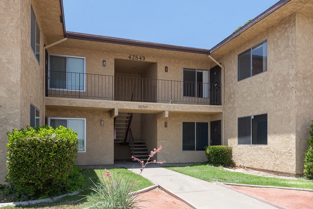 Welcome to Park Somerset! This upstairs 2-bedroom, 2-bath condo in West Lancaster offers comfort, convenience, and one of the best locations in the community. Unit #4 is situated just steps from the sparkling pool, spa, and management office, with direct access from street parking or within the gated complex. A private garage is also included. Inside, you'll find nearly new luxury vinyl plank flooring, a bright and spacious living room with fireplace, and an updated kitchen with newer appliances. The in-unit laundry closet includes washer and dryer. Enjoy peaceful mornings on your private balcony with views of the pool, mature trees, and open space. With 1,228 sq ft of space, central HVAC, and a layout designed for privacy and flow, this move-in-ready home is ideal for first-time buyers or investors. All located just across from Costco and the 14 Freeway entrance for unbeatable access.