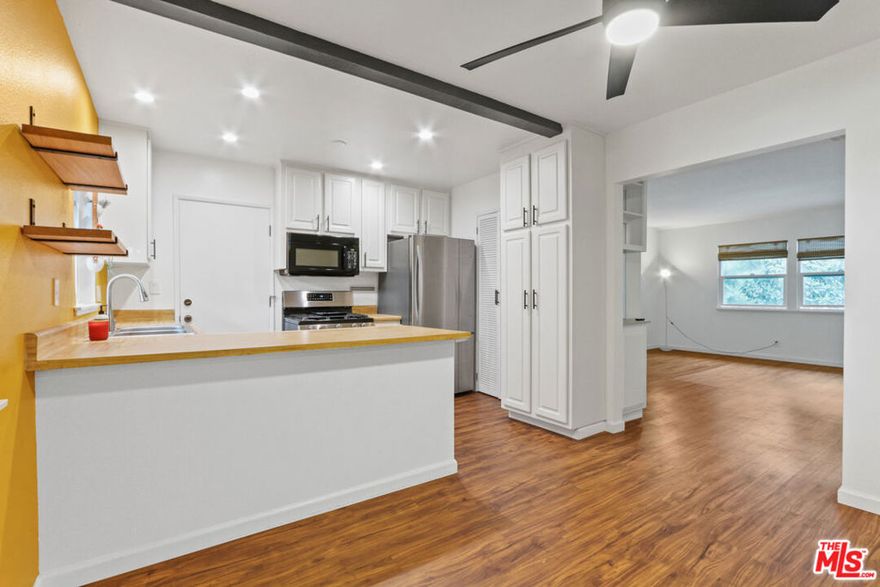 Light and bright top floor 2bed + 1.5bath condo in Cameo Woods. This spacious 903sf unit has tree top views and both east, west & south facing windows. Beautifully updated, the open living room boasts newly updated vinyl plank flooring and vinyl windows. The kitchen features stainless steel appliances, modern floating shelves plus lots of cabinet space, extra storage and pantry space, + separate dining area as well as a combo washer/dryer. 2 spacious and light filled bedrooms with large closets and a closet system. More upgrades include the recently remodeled full bath with new vanity, oversized coat closet with shelving + a designer 1/2 bath just outside the 2nd bedroom. 1 car private garage parking included. This gated community with 24/7 security features a plethora of green space, a pool, two hot tubs, a dog park, community garden, clubhouse and a tennis court. Just a few blocks to the Expo line, Target, Whole Foods, Cliffs of Id & Gym Tonic. Close to Culver City shopping like Trader Joes, Monroe Place, Juliet, Breakaway Cafe, Sephora, Salt & Straw,  Culver City Farmers Market, Hi Lo Liquor, Pasta Sisters and more. Feel like a hike? There's Kenneth Hahn Park, the bike path to the beach, Culver City stairs and Baldwin Hills Scenic Overlook just around the corner. Apple, Amazon, Nike and HBO are all conveniently located close by. Minutes to DTLA, Santa Monica, LAX and Hollywood. Don't miss out on all this condo has to offer!