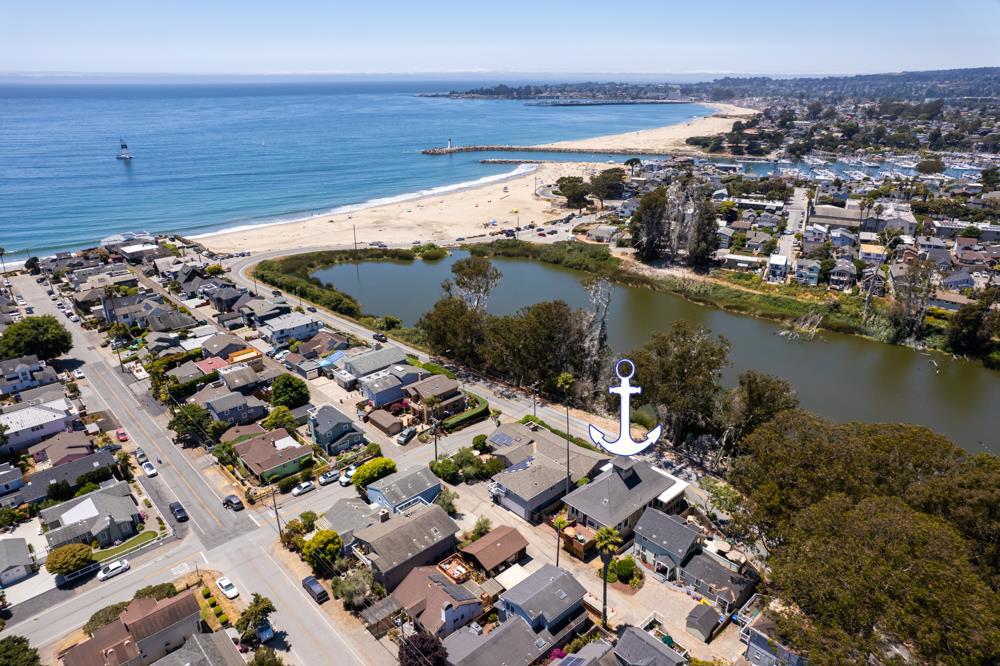 Hidden in an alley just steps from the stairs to 12th Avenue Beach, which are bookended by Black Point and the Santa Cruz Yacht Harbor, you can find the majestic beach mansionone of the first Craftsman-style homes, built in 1904. This lifestyle property offers beautiful, unique views of Schwann Lake and Twin Lakes Beach while being conveniently close to excellent restaurants, coffee shops, yachting, shopping, and the best farmers' market in town! Draped in history and for decades, the home was filled with writers, artists, potters, poets, musicians, and creatives alike. This grand beauty is ready for its next chapter, flaunting great bones, a historic designation, legal duplex status, classic Craftsman wrap-around porches, and endless possibilities. The upstairs is full of vintage built-ins, long-lived fixtures, fathomless books, and ornate carvings still holding the memories of family, friends, celebrations, and laughter, while the first-floor rooms are skillfully arranged, like origami. There are a multitude of windows on every level. While the salty air and ocean elements can be harsh on the peeling paint so near to the sea, don't worrythis Majestys story is not over; it is just a new beginning. Make your beach dreams come true, the possibilities are truly endless here!