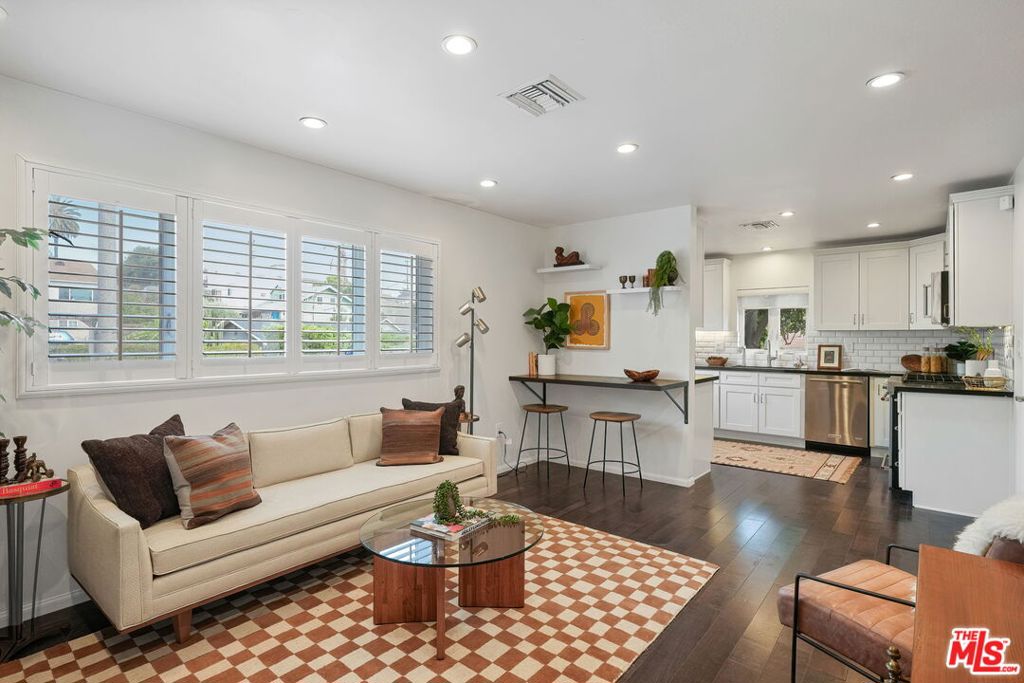 Fully remodeled in 2016, this charming 2-bedroom, 2.5-bath bungalow sits on the border of Silver Lake and Echo Park - nestled in one of LA's most walkable neighborhoods. Step inside to an open-concept layout enhanced by recessed lighting on smart dimmers, creating a warm, modern ambiance throughout. The thoughtfully designed kitchen features quartz countertops, soft-close cabinetry, a walk-in pantry, high-end stainless steel appliances, and a Waterdrop reverse osmosis filtration system, perfect for the home chef. Both spacious bedrooms are thoughtfully positioned on opposite sides of the home for privacy, each offering a chic en-suite bath and custom closets. A stylish guest powder room adds convenience, while a separate laundry room provides extra storage and functionality. The private driveway, secured by an automatic sliding wood gate, accommodates two vehicles and doubles as an additional entertaining area. Out back, the fully fenced yard transforms into an urban retreat, complete with a built-in natural gas fireplace, ideal for cozy evenings or weekend gatherings. EV owners will appreciate the dedicated 100-amp panel, Tesla wall connector, NEMA 14-50 outlet, and a time-of-use meter for optimized energy efficiency. All of this, just a 5-minute stroll to Sunset Blvd's cafes and eateries, 10 minutes to local bars and coffee shops, and within walking distance of Echo Park Lake and Dodger Stadium. A smart layout. A prime location. A home that checks every box. Don't miss this one.