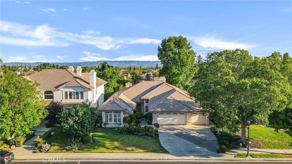Nestled in the prestigious Ridgegate community of Porter Ranch, discover a lifestyle of luxury & comfort. The elegant guard-gated entrance, pride of ownership that resonates throughout this upscale neighborhood, Stepping inside this remarkable single-story residence, over 3,500 square feet of thoughtfully designed living space, all set on an impressive 11,000 square foot lot. This magnificent single story home features 5 bedrooms and 5 baths. Impressive soaring ceilings & grand walkway create a breathtaking first impression, hinting at the beauty that lies beyond. Sophisticated living room, where natural light dances through the windows, soaring ceilings accentuating the space.The formal dining room flows seamlessly into the chef’s kitchen, a culinary paradise equipped with stainless steel appliances, built in refrigerator. Granite countertops & expansive center island offer ample space for meal preparation. Cozy breakfast nook provides a delightful spot to savor your morning coffee, easy access to the beautiful backyard and covered patio.The family room with soaring ceilings and wet bar, serves as the perfect gathering place. Its statement fireplace draws you in, making it an inviting space for family, friends to unwind & create lasting memories. Retreat to the primary suite, a true sanctuary featuring coffered ceilings,walk-in closet. The ensuite bathroom offers a spa-like experience with a separate shower and soaking tub, alongside dual vanities that eliminate the hassle of sharing. Four additional spacious bedrooms, each with its own ensuite bathroom, ensure that everyone has their own private haven. Low-maintenance backyard is a serene escape, a covered patio,vibrant landscaping, including blooming flowers that bring joy throughout the seasons. It’s the perfect setting for al fresco dining or special evening gatherings.This home is not only beautiful but also equipped with modern conveniences. This home checks every box—a perfect blend of elegance, functionality, and comfort. Premier schools, Granada, Nobel & Beckford. This is more than just a residence; it’s a place where you can truly fall in love with life. Don’t miss your chance to call it yours.
