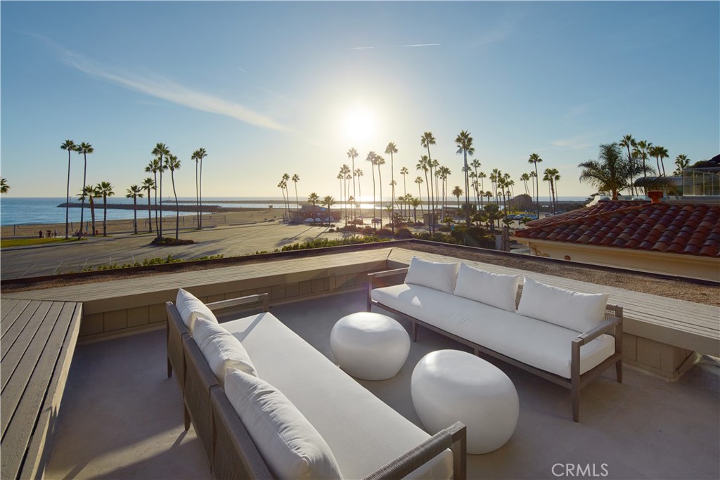 Just feet from the sand in Corona del Mar, behind the gates of the exclusive Breakers Drive enclave and on the market for the first time since its construction, this once-in-a-lifetime residence overlooks Big Corona Beach, the stone jetties that line Newport Harbor’s entrance channel, Catalina Island, breaking waves, and dramatic coastline bluffs. Virtually hidden from the street above and exceptionally private on every level, this coastal gem of approximately 5,084 square feet consists of a 5-bedroom, 3.5-bath main residence, and a separate 2-bedroom, 2-bath ADU with front-row ocean views which is currently leased and offers outstanding income potential. The home’s private entry introduces the lowest floor and hosts an office or bedroom with ensuite bath and a wet bar. Offering separate outside access, a media lounge with tray ceiling and wet bar can easily become a studio or home gym. Floating stairs lead to the main level of the residence, which impresses with stunning ocean and beach views, a towering double-height vaulted ceiling with floor-to-ceiling windows, access to a spacious ocean-view terrace, a fireplace with bookmatched stone surrounds, a wet bar, and a dining room with built-in buffet. An island kitchen shines with granite countertops, Thermador and Sub-Zero appliances, and a fireplace-warmed breakfast room opening to a private rear patio with automated sprinklers. Locking gates lead from the patio to the street behind and a short stroll to Corona del Mar’s village shops and restaurants. The patio can also be reached by a wood-paneled guest room. On the top floor, an open landing overlooks the living room below and leads to two ocean-view guest rooms, with one leading to a beach-view balcony, and another offering access to a private rear balcony. Separate from the guest bedrooms, the primary suite is fully appointed with a balcony overlooking the ocean, a cedar-lined walk-in closet and a sauna with door to the rear balcony. Mid-Century style is complemented by clerestory windows, vaulted open-beam ceilings, custom built-ins, and a period-perfect intercom system. Enjoy easy access to Big Corona’s broad beach, tide pools, Fashion Island, Pelican Hill, and John Wayne Airport.