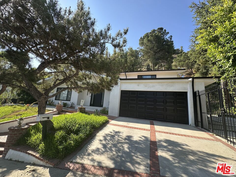 Welcome to 9781 Blantyre Drive a beautifully remodeled 3-bedroom, 3-bathroom home nestled in a serene Beverly Hills cul-de-sac. This 2,135 sq ft residence, set on a generous 0.66-acre lot, combines mid-century charm with modern updates, offering a tranquil retreat in the prestigious Beverly Crest neighborhood. Inside, the home features a spacious layout with updated interiors, including hardwood flooring and a contemporary kitchen equipped with modern appliances. The living areas are designed for comfort and style, providing ample space for relaxation and entertainment. The expansive backyard is a standout feature, boasting a well-maintained retaining wall and ample space for outdoor activities or future landscaping projects. Situated in a quiet cul-de-sac, the property ensures privacy and minimal traffic, enhancing the peaceful living experience. Located within the Los Angeles Unified School District, residents have access to quality education options. The home's proximity to city amenities, coupled with its secluded setting, offers the best of both worlds.
