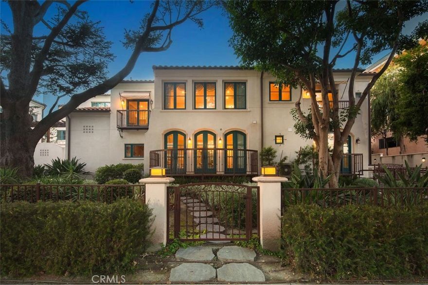 Tucked beneath the foothills of the San Gabriel Mountains, this detached Spanish-style townhouse in Pasadena evokes a quiet sense of elegance, where form and function are finely attuned. Defined by its soft arched windows, terracotta rooflines, and serene garden approach, the home pays homage to timeless Californian architecture while embracing a distinctly modern sensibility. Inside, the double-height living area is drenched in natural light, framed by tall French doors that invite the outdoors inward. A restrained palette of warm timber floors, crisp white walls, and custom built-ins grounds the home in calm. The kitchen is a deliberate contrast of sleek, minimalist cabinetry paired with polished stone surfaces and a subtle mosaic backsplash, reflecting a contemporary shift in tone and function. Three generous bedrooms are thoughtfully arranged, with one downstairs and the others on the second floor, providing retreat and rhythm to the layout. The primary suite captures leafy outlooks and offers a quiet refuge, complete with a spa-inspired ensuite and considered storage solutions. With direct access to two underground garage spaces and a location just moments from Pasadena’s cultural and commercial heart, this residence balances privacy with urban connection. It is a home that values detail and longevity and in doing so, carves out a space that feels both intimate and enduring.