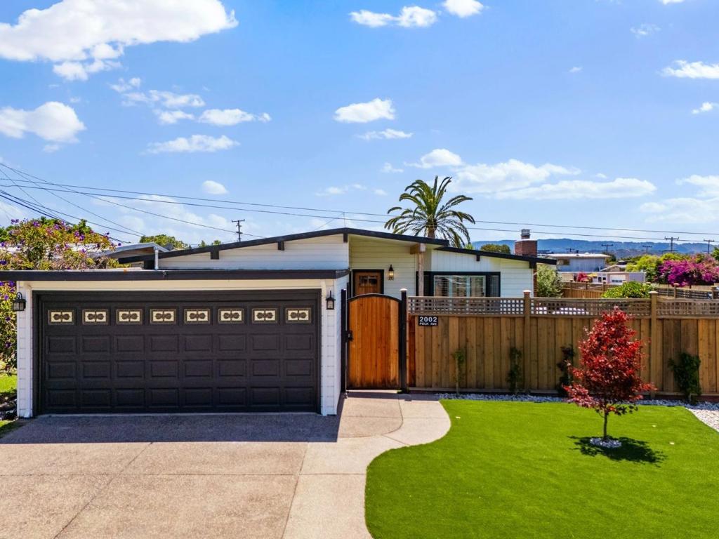Discover a coastal modern retreat on a sun-kissed large corner lot in San Mateo's Parkside. Inside, vaulted ceilings, abundant windows, skylights, and refinished white oak floors create an airy backdrop for daily life. The quartz wrapped kitchen pairs GE Profile appliances, wine fridge, peninsula seating, and farmhouse sink with custom cabinetry, pull out drawers, and a true pantry, ideal for weeknight cooking or Sunday brunch with friends. Three spacious bedrooms include a private en-suite primary retreat. Both divinely renovated full baths feature oversized walk-in showers with a spa-inspired feel. A rare full size laundry room adds a folding counter, hanging rack and built ins, while updated electrical and plumbing, USB ready outlets, A/C, and Tesla charger provide modern peace of mind. Out back, a coded gate opens to a low-maintenance wraparound yard: paver patios for alfresco dinners, turf lawn for play, and a fully powered Tuff Shed perfect for an office, gym, or studio space. Leave the car and stroll to Joinville Parks pool, pickleball, dog park, and the Bay Trail, or launch boats and kayaks from the neighborhood beach. Shops, dining, and Hwys 101/92 are minutes away. Designed for modern living and effortless entertaining. This is San Mateo living at its best.