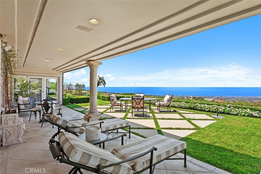 This stunning custom home boasts absolutely breathtaking, panoramic 180-degree views of the coastline featuring dramatic views of Catalina, the Newport Harbor, Palos Verdes, and Los Angeles. Extensively renovated in 2019 , the impeccable quality craftsmanship is evident throughout. The dramatic entry has cathedral ceilings and features a formal dining room to the left with custom wood paneling and a formal living room to the right with marble fireplace, custom cabinetry, and beautiful walnut hardwood floors throughout.
The great room concept features a gourmet kitchen that is a chef's dream, featuring Rosso Levanto marble countertops, a full-size Subzero refrigerator and freezer, and Thermador appliances, including a six-burner stove with a griddle, double ovens, and a microwave with a heating drawer and delightful barstool seating and dining table. The kitchen also opens to a wet bar area complete with a Subzero wine fridge, two GE drink drawers, a GE Monogram wine fridge, a KitchenAid ice machine, and a spacious family room perfect for entertaining.
The downstairs level also includes a guest bedroom en-suite with a marble shower and Carrera marble accents, a dedicated laundry area with a Maytag washer and dryer. Upstairs, you'll find three bedrooms, an office, bonus room, a gym, and a luxurious primary suite with a sitting area, marble fireplace, and incredible views. Other features include a large walk-in closet and a lavish bathroom featuring Crema Marfil marble floors and countertops.
The home is in pristine condition, offering modern luxury, timeless elegance, and exceptional views, three car garage, gated entry, and lush gardens is ideal for those seeking a move-in-ready residence in the highly sought-after community of Spyglass Hill in Corona Del Mar.