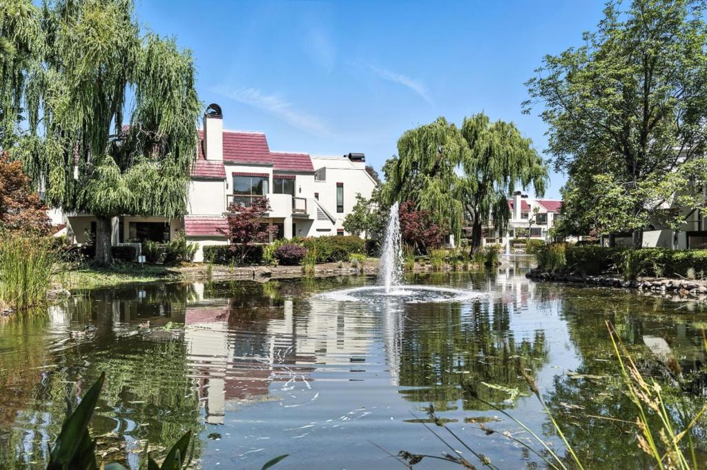 Wing it to 221 Shorebird Circle for a birds eye view of a willow-lined lake. This picturesque landscape is a welcome sight from the Great Room and bedrooms of this two-story, upper floor corner 2BD, 2BA condo. Go up the private exterior stairway to find an open plan layout: living quarters, bathroom and primary bedroom downstairs; an ensuite loft upstairs. The great room showcases a vaulted ceiling, a sliding glass door out to a spacious wrap-around balcony, a wood-burning fireplace and a spiral staircase. Enjoy an al fresco lifestyle on the balcony: morning coffee off the bedroom, happy hour off the Great Room. The kitchen features an over-the-sink garden window and a pass-through breakfast bar. Spacious pantry is opposite an in-unit laundry. The aerie atop the spiral staircase can serve as an ensuite bedroom or home office or be turned into a hybrid: guest room/exercise room/arts studio/workshop/storage. The skys the limit. 2 assigned parking spaces. 2 pools and spas, clubhouse, kayak storage, boat launch. Nearby tennis courts, library, scenic trails, parks, birdwatching. Close to major commute routes,101, 92, 280, Belmont Caltrain, SFO, OAK, SJC. Beat the flock to Shorebird. Migrate to an airy perch in an oasis of serenity, overlooking water and willows. Happy landings.