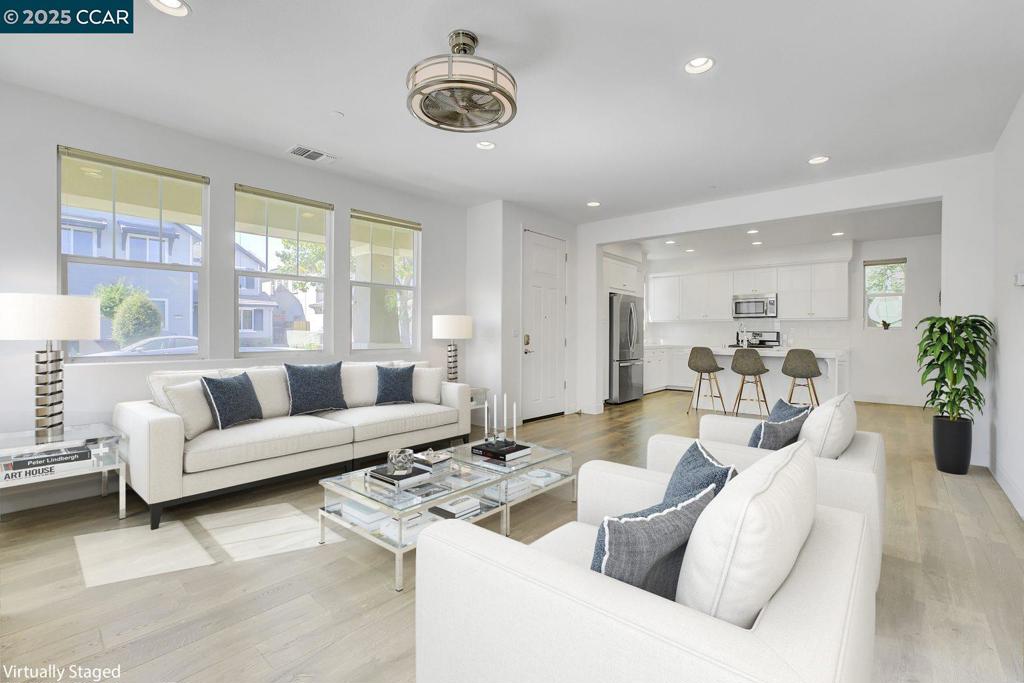 Built in 2015, this contemporary home in the highly sought-after Palmilla community is move-in ready. Enjoy lush communal parks, well-maintained tree-lined streets, family-friendly atmosphere and serene strolls. Inside, the bright, open-concept living area seamlessly connects the living, dining, and kitchen spaces, with high ceilings enhancing the airy ambiance. The spacious kitchen features modern appliances, island, and ample storage. The low-maintenance backyard boasts fruit trees, diverse plants, and a paved patio perfect for entertaining. Upstairs, you'll find generous bedrooms, a versatile loft, and a primary suite with a spacious walk-in closet and en-suite bath. Pride of ownership shines through in this meticulously cared-for home, complete with a Tesla charger inside the 2-car garage and new washer, dryer, and fridge, and flat screen 3DTV—all included. This prime location offers easy access to shopping, dining, excellent schools, major highways, walking trails, a short walking distance to the BART shuttle, movie theater, and farmer's market. Don't miss the chance to make this exceptional property your own!