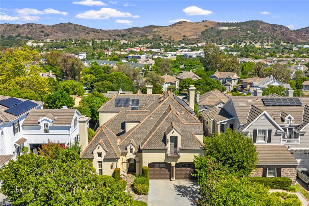 Welcome to Belmont Hill, one of Ladera Ranch’s most desirable cul-de-sacs! This beautifully upgraded 4 bed / 3.5 bath view home offers elegance and comfort throughout. Interior highlights include newer luxury vinyl flooring, new carpet, custom paint, crown molding, plantation shutters, and upgraded baseboards. The gourmet kitchen boasts rich cabinetry, quartz countertops, a spacious center island with breakfast bar, six-burner cooktop, double oven, built-in desk, and breakfast nook. The inviting family room features a custom media niche, surround sound, and fireplace with custom mantle. A main floor bedroom with private bath is perfect for guests. Upstairs, the newly remodeled primary suite showcases an enlarged shower with separate soaking tub, dual vanities with new faucets and quartz countertops, walk-in custom closet, and a private covered deck with sweeping views. The large backyard with incredible views is designed for entertaining with a spa, covered patio, and outdoor fireplace. Enjoy resort-style living close to Ladera’s top amenities including Flintridge Clubhouse, pools, parks, schools, and shopping. A must-see opportunity in one of Orange County’s premier neighborhoods!