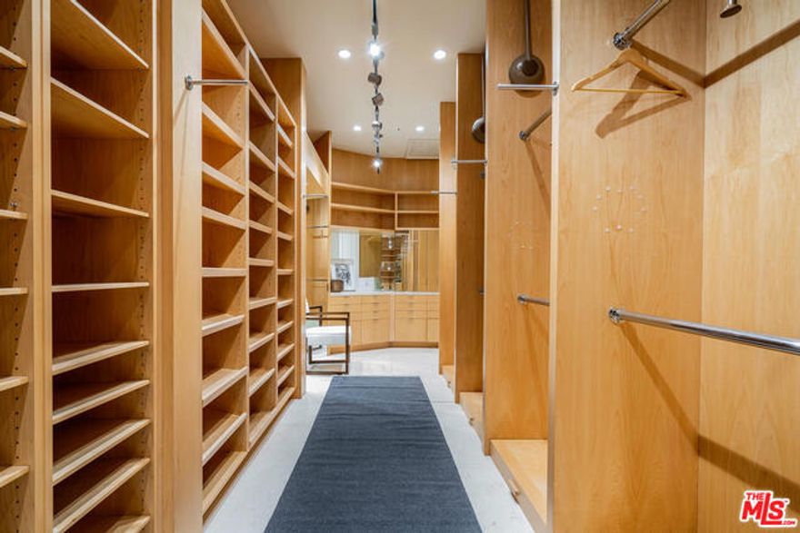 Spectacular Mediterranean villa in prestigious Mulholland Estates. Incredible volume and proportions throughout. A seamless floor plan, magnificent scale, and a palette of warm earth tones combine to deliver a perfect package. French doors open to back yard from almost every room on the first floor, creating sunlit public rooms. Gracious and elegant, this estate boasts formal entrance with beautiful curved staircase and formal living room with fireplace. Enormous family room off kitchen is perfect for large parties or intimate gatherings. Chef's kitchen opens to patio, and outdoor kitchen, great for al fresco dining. Three en suite bedrooms upstairs. Master has sumptuous bath and oversized his and her closets. Maids room on first floor. Three car garage. Private, lush yard with pool. An unparralleled opportunity to live in this coveted gated community at an irresistible price point!