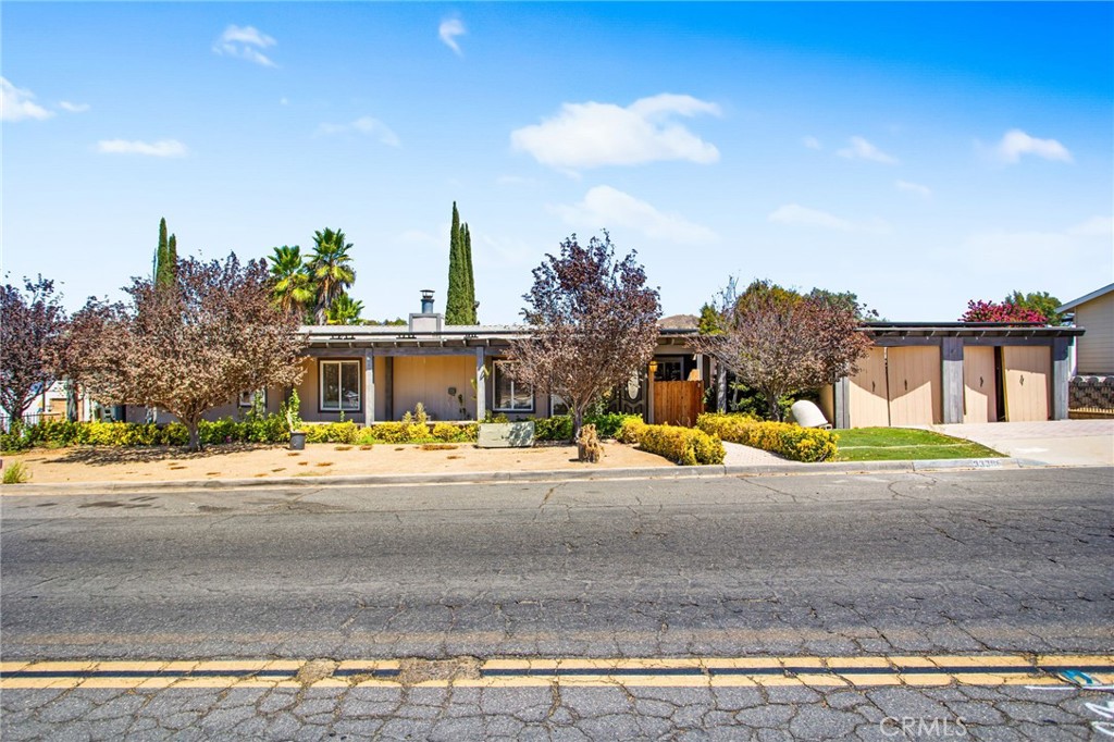 Located in Wildomar’s The Farm this unique residence, undoubtedly offers more than any you’ve seen! Featuring a primary structure with wide open living space, an attached ADU with separate entrance +2 more detached ADUs perfect for extended family or even better income potential! The main residence offers an updated layout with bright white interior walls, laminate and tile flooring throughout, a beautiful floor to ceiling stone fireplace, two bedrooms, one being the primary with updated bathroom including large soaking tub and walk in shower, a spare bath for guests, huge kitchen with tons of cabinet space, extra large island, custom floors, dining area, desk area, plenty of windows letting natural light pouring through all angles and direct access through french doors leading out to the back deck. Here's where it gets even better!! Attached to the main residence is your first ADU offering a full kitchen with granite countertops, gray oak cabinets, bar top seating, living space with doors leading out to the back deck, a well sized bedroom, full bathroom with updated shower stall, access to the main house and a private entrance for times when you don't want to be bothered by your guest! The two additional ADUs offer private entrances, kitchens, 1 bedroom/bathroom each and a living space!!! If outdoor space is your thing, this one will not disappoint with a huge deck, leading directly off of the primary structure yet offering access from all ADU’s allowing for privacy or the occasional entertainers paradise for those evenings with friends and family!! To top it off you have a full width porch on the front with mature landscaping and turf, two carports with doors to close your vehicles off from the street and last but not lest solar that helps to offset your energy consumption! Living in The Farm is an adventure in and of itself with three pools, two spas, tennis and sport courts, fishing, pond, trails, RV parking, community owned citrus trees, community event/activities and more! A unique opportunity like this doesn't present itself often so take advantage before it's too late!!