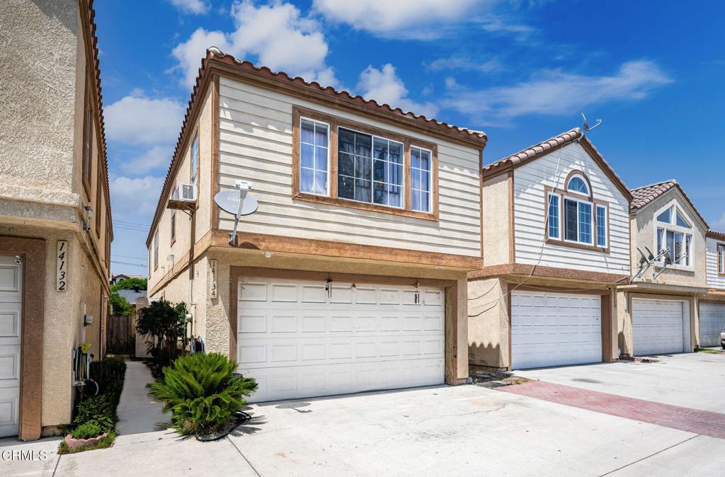 Welcome to this spacious two-story detached townhouse nestled in the heart of Paramount. Perfect for buyers looking to add their personal touch, this home offers the ideal combination of space, convenience, and potential. As you enter, you'll immediately notice the bright and open layout. The main level features a step-down living room with direct access to a large private patio, a perfect spot for entertaining guests, enjoying your morning coffee, or hosting weekend barbecues. Just off the living area is a dedicated dining space and a convenient half bathroom, ideal for guests.The kitchen offers direct entry to the attached two-car garage, making unloading groceries a breeze. While the home does need a bit of TLC, it provides a foundation to update and personalize to your own taste and modern comforts. Upstairs, you'll find two spacious Jack and Jill bedrooms, connected by a shared bathroom. These rooms feature high ceilings and ample natural light, creating a warm and inviting atmosphere. The expansive primary suite is a standout, offering high ceilings, generous closet space, and a private en-suite bathroom for added comfort and privacy. For added convenience, the laundry area is located upstairs, making laundry day simpler and more efficient. This home is ideally located near local schools, shopping centers, restaurants, and major freeways, offering quick access to everything you need--whether you're commuting to work or enjoying the local amenities. With a bit of love and vision, this property can truly shine. Don't miss your opportunity to invest in a spacious home with incredible potential!