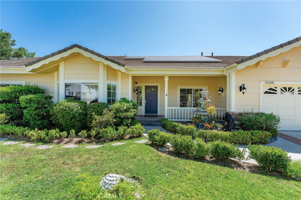 Sprawling single story upgraded estate privately situated at the very end of a quiet cul-de-sac of only 5 homes in one of the most desirable neighborhoods in Chatsworth. Located on an impressive 18,000+ SF flat lot, the property features superb curb appeal with nicely landscaped front yard, 3-car garage with large finished attic and built-in storage, & additional extra wide gated driveway perfect for RV/boat/extra parking for large gatherings. A covered front porch greets you before stepping inside the double door entry. The grand foyer opens to both a formal living room with vaulted ceiling as well as a separate formal dining room with tray ceiling, open shelves, & real hardwood flooring found throughout. The stunning completely remodeled open kitchen boasts gorgeous quartzite stone counters, center island with breakfast bar seating, stainless Cafe appliances including double ovens & 6-burner stove with pot filler, & walk-in pantry with built-in storage & pullouts. The kitchen opens to a separate family room with soaring wood beamed vaulted ceiling & stone fireplace. An additional sunlit bonus room located off the family room features wall-to-wall picture windows, two sets of glass sliders that open to the yard, & wood beamed vaulted ceiling. There are 5 spacious bedrooms including the primary suite featuring high vaulted ceiling, walk-in closet with additional wardrobe closet, & private en-suite upgraded bathroom with dual sinks, quartz counters, bath tub, walk-in shower, & separate toilet room. Two of the secondary bedrooms are massive suites, each with walk-in closets that share an oversized bathroom with dual vanities, tub, shower & built-in linen storage. The 4th bedroom has an en-suite bathroom with dual sinks, tub & shower. The 5th bedroom is located on its own wing of the house ideal for guests with access to its own upgraded bathroom. Additional living spaces include craft room/office, laundry room, & guest powder bathroom. The incredible park-like backyard is an entertainer’s dream featuring large grass lawns with walking path, covered patio with built-in heaters & fan, BBQ center with two grills & sink, above ground spa, & numerous fruit trees including grapefruit, Meyer lemon, blood orange, & plum to name a few. Huge energy savings with completely paid for solar panels. Located adjacent to horse trails, hiking, parks, dining/shopping at the Westfield Mall/Village, & easy access to the 118 freeway. Don’t miss this spectacular offering!