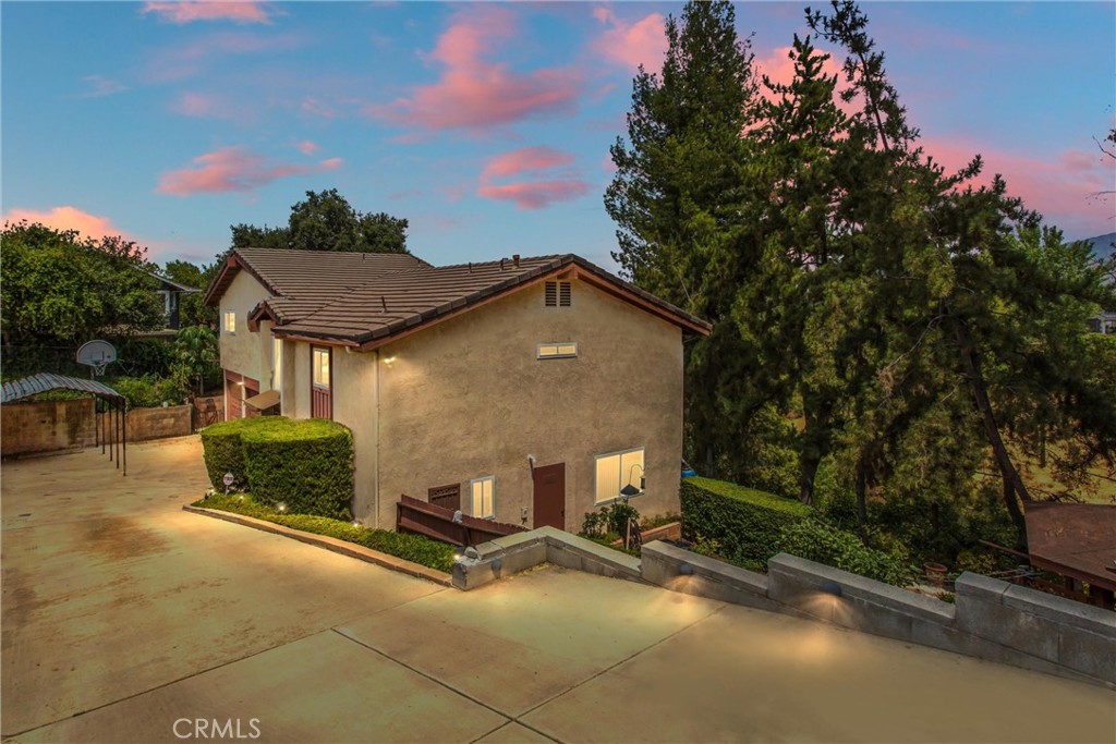 This is an amazing home with so much to offer and holds many fun memories for the children who grew up exploring the oversized land.
Entering the main floor, you will find the living room and formal dining area with a sliding glass door from the living room leading onto a deck which overlooks the entire yard along with a garden for raising fresh vegetables. Walking into the kitchen you will see all the upgrades with granite counters, stainless steel sinks, loads of cabinetry along with a 5 burner gas range. There is also access into the kitchen from the entry with a pocket door. To make the move easier the refrigerator is included. Just steps away into the laundry room there are cabinets, a washer and an electric dryer, but if you prefer there is a gas outlet for a dryer. For convenience there is a half bath off the laundry room, and there is a door and security screen door to the outside. Altogether there are 3 security screen doors.
Up the stairs from the entry are two bedrooms, an upgraded full bath with 2 sinks, as well as a family room with ceiling fan and a wood burning fire stove. Another deck leads out from the family room. The third level is where you will find the great primary bedroom with a separate spacious sitting area or office. There is a wonderful walk-in closet, and another upgraded bathroom that you will admire with double sinks, lovely granite counter and a huge shower.
A Navien Tankless hot water heater was installed about 6 months ago, and to save on electricity there is a whole house fan. For outside entertaining there is a barbeque that is included and a wonderful covered gazebo featuring lights, a ceiling fan plus additional electrical outlets. The added bonus is a spa for relaxation after a long busy day.