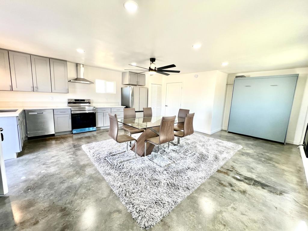 Experience the charm of desert living with this fully remodeled 480-square-foot residential CABIN/ RECREATIONAL USE, perfectly situated on 2.5 acres in the tranquil landscape of Landers, CA. This beautifully updated cabin features a modern open kitchen, a convenient laundry closet, and a spa-like bathroom with a walk-in tile shower. The property is equipped with a brand-new septic tank, adding to its appeal and functionality.Step outside to take in the breathtaking desert views and enjoy the thoughtfully designed outdoor spaces, including a BBQ area, cozy fire pit, and even an outdoor bathroom for added convenience. For outdoor enthusiasts, the property boasts three full RV hookups, making it ideal for hosting guests, gatherings, or weekend adventures. Located near the renowned King of the Hammers, this property offers quick access to world-class off-road experiences while providing a peaceful retreat with panoramic desert vistas. Whether you're looking for a weekend getaway or a base for desert exploration, this cabin seamlessly blends comfort, functionality, and rugged beauty. Property is zoned as a residential cabin. There is a 4,000-gallon structure underground next to the property that offers creative potential--it can be used for storage, a man cave, or other imaginative purposes.