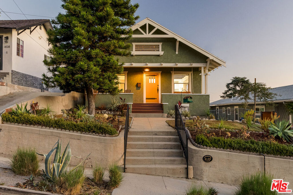 Welcome to 6134 Strickland Ave, a storybook Craftsman on a quiet street in Highland Park. A long driveway and inviting front porch lead to the bright, open-concept living space. The living room's ceiling accents and natural flow connect to a dining area with a built-in window nook that provides extra seating and storage. The remodeled kitchen features a breakfast bar and opens to a spacious wraparound deck, perfect for morning coffee or entertaining. With three bedrooms, two full baths, and a separate laundry area, the layout includes a sun-filled primary suite overlooking the dreamy backyard oasis. Mature landscaping, garden beds, a cowboy-style plunge pool, covered patio, and turf yard create the ideal outdoor space for relaxing or hosting. Notable upgrades include newer HVAC, retaining wall, drip irrigation, engineered hardwood floors, and tankless water heater. Move-in ready and full of Highland Park charm, this timeless Craftsman offers the perfect blend of character, comfort, and California indoor-outdoor living. A Must See!