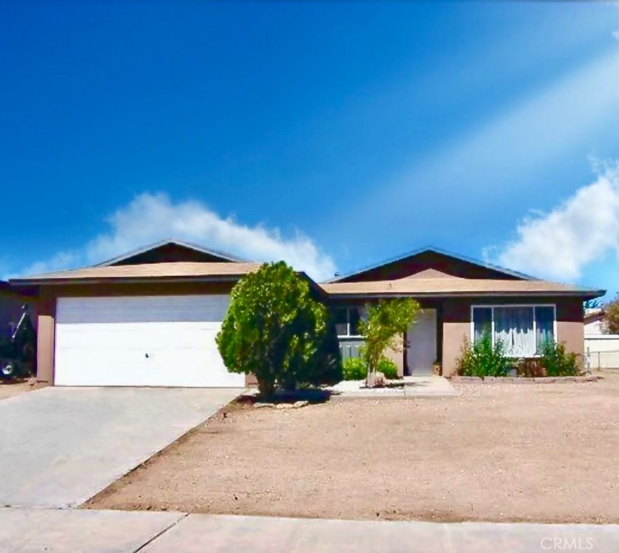 FRESH NEW LOOK! Recently Painted Exterior gives this Home Fantastic Curb Appeal. Offering 3 Bedrooms, 2 Bathrooms, and 1,352 Sq. ft. of Living Space, this Property has Been Thoughtfully Updated Throughout. Inside, You'll Find a Thoughtfully Updated Floor Plan with a Spacious Living Room Featuring a Recessed Niche Perfect for Storage or an Entertainment Center Plus a Mini Split System for Efficient Heating and Cooling. The Remodeled Kitchen Offers Modern Corian Countertops with Backsplash, Upgraded Sink, Faucet, Microwave, Dishwasher, and a Stylish Light Fixture above the Sink. Additional Updates Include Newer Lighting in the Family area Accented by Relaxing Sea-Blue Tones. Throughout the Home, Enjoy New Laminate Plank Flooring and New Windows that Bring in Abundant Natural Light while Improving Energy Efficiency. Both Bathrooms have Been Tastefully Remodeled with Fresh Paint, Mirrors, Lighting, Faucets, and Water-Efficient Toilets. Bedrooms Feature Newer Ceiling Fans, and Generous Closet Space. Step Outside to a Large Stone-Floored Covered Patio Perfect for Summer Gatherings and BBQs. Low-Maintenance, Water-Wise Landscaping Makes Upkeep Easy. Ideally Located Near a Charter School, IWV Baseball Fields, and Surrounded by a Family-Friendly Neighborhood. A Wonderful Opportunity to Own a Beautifully Updated, Move-In Ready Home!